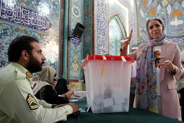 <p>An Iranian woman shows her ink-stained finger after casting her ballot at a polling station, in Tehran </p>