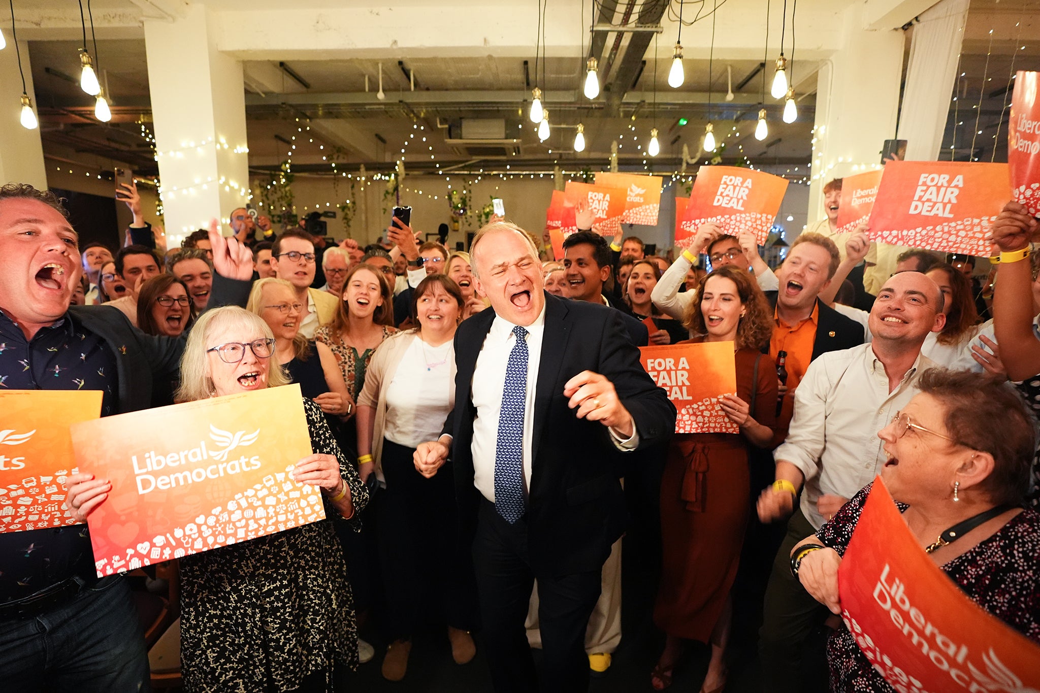 Ed Davey and his supporters watch the election results come in at a bar in London