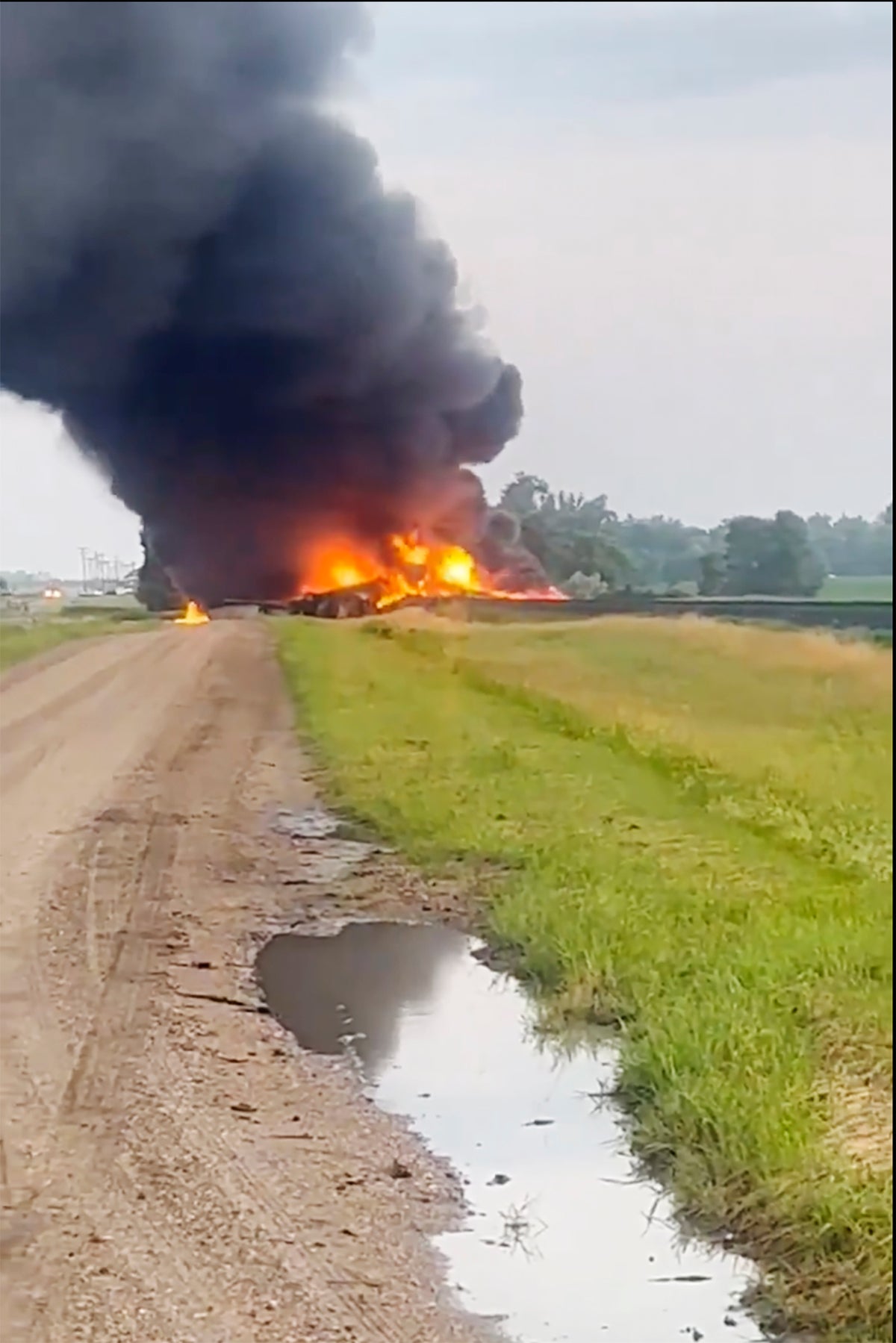 Train carrying hazardous material derails in North Dakota and catches fire