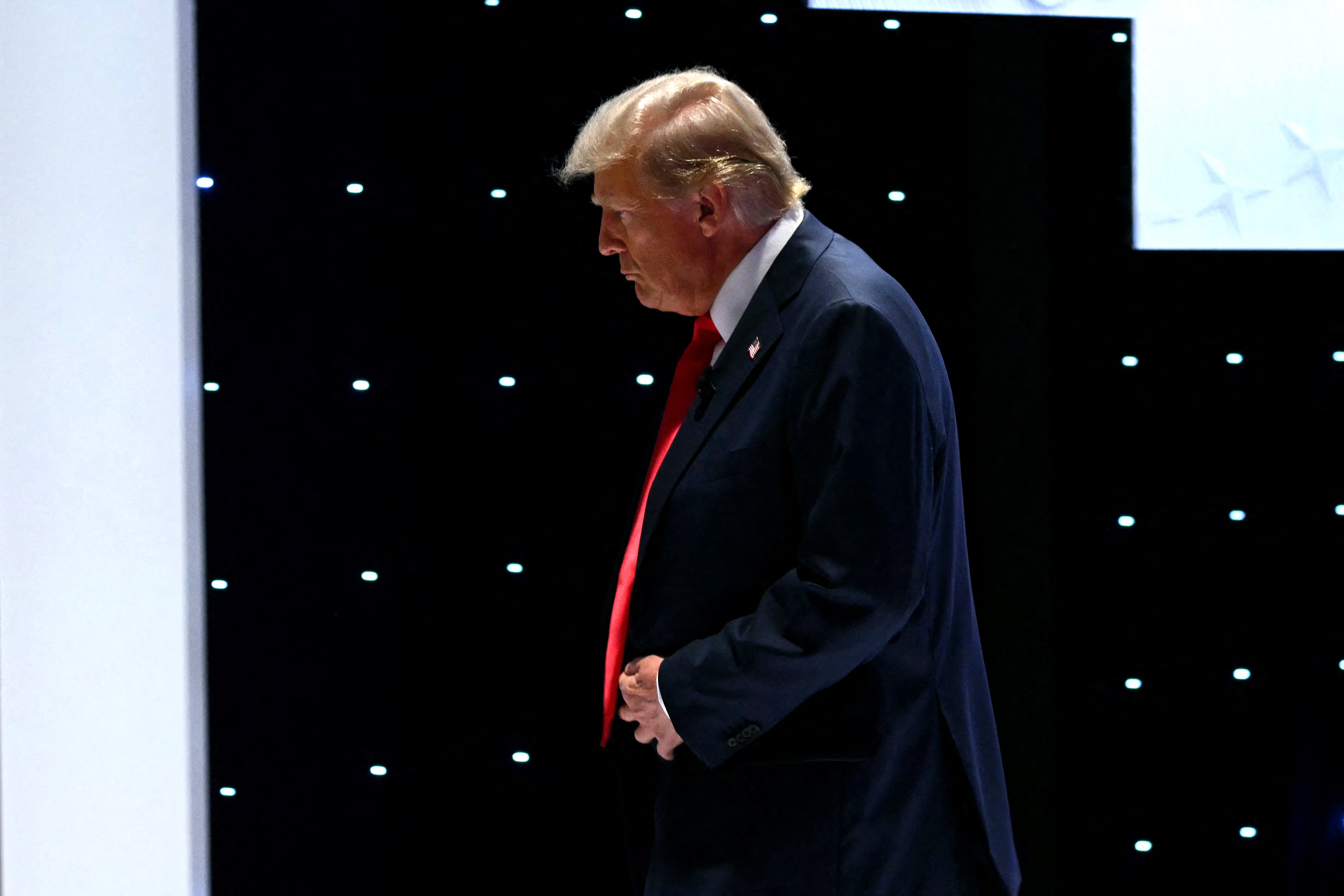 Donald Trump walks off the stage following a highly contested debate in which he has received little criticism