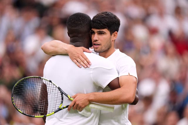 <p>Carlos Alcaraz embraces Frances Tiafoe at the net after their match</p>