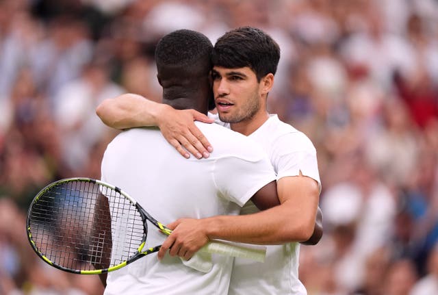 <p>Carlos Alcaraz embraces Frances Tiafoe at the net after their match</p>