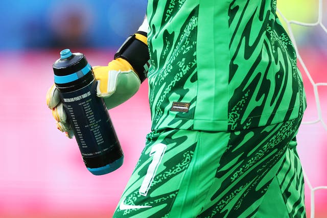 <p>Jordan Pickford holds a water bottle with his penalty tips</p>