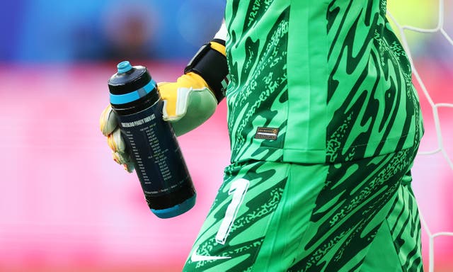 <p>Jordan Pickford holds a water bottle with his penalty tips</p>