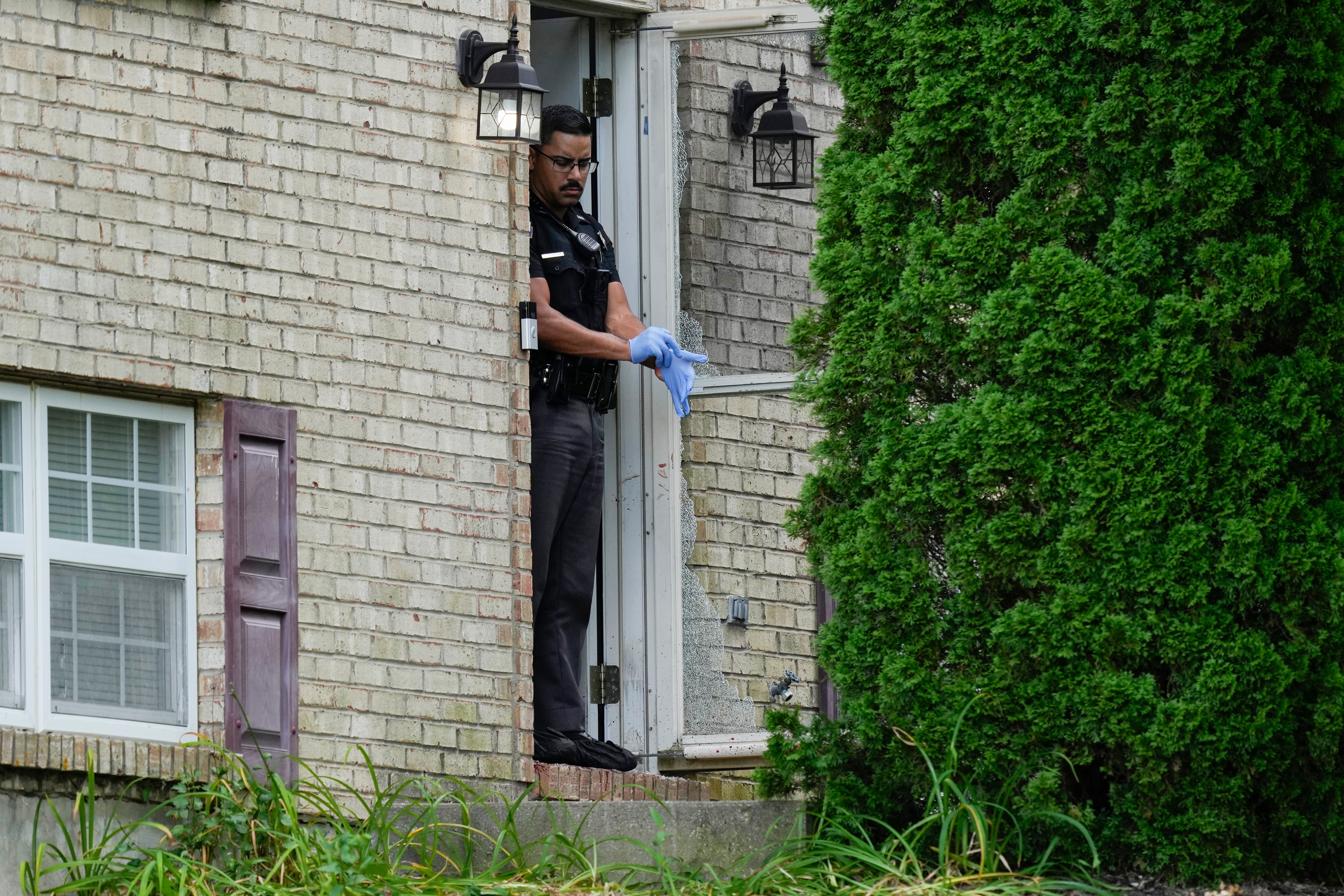 An officer leaving the scene of the shooting