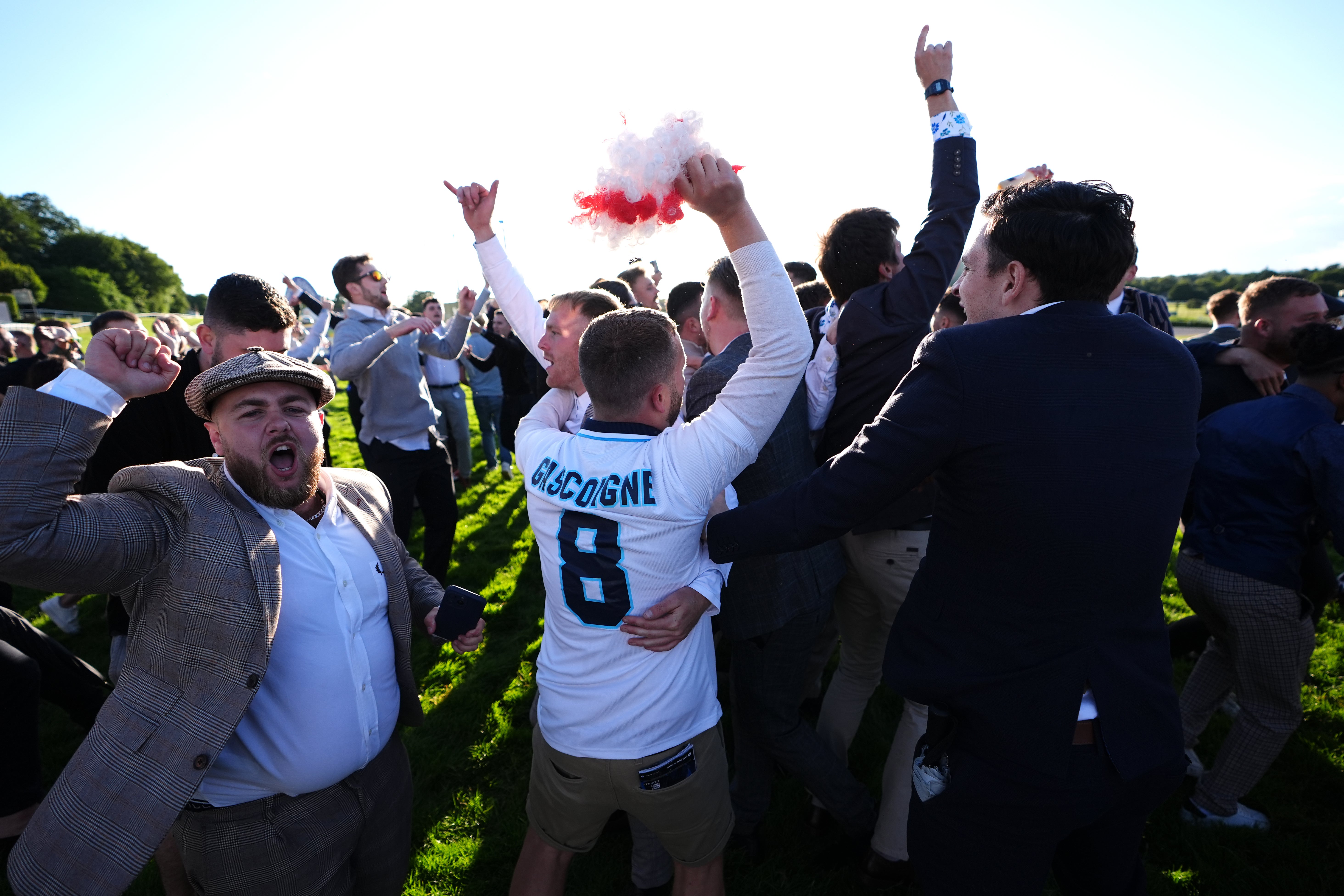 England fans celebrate on the race track at Sandown Park (Zac Goodwin/PA)