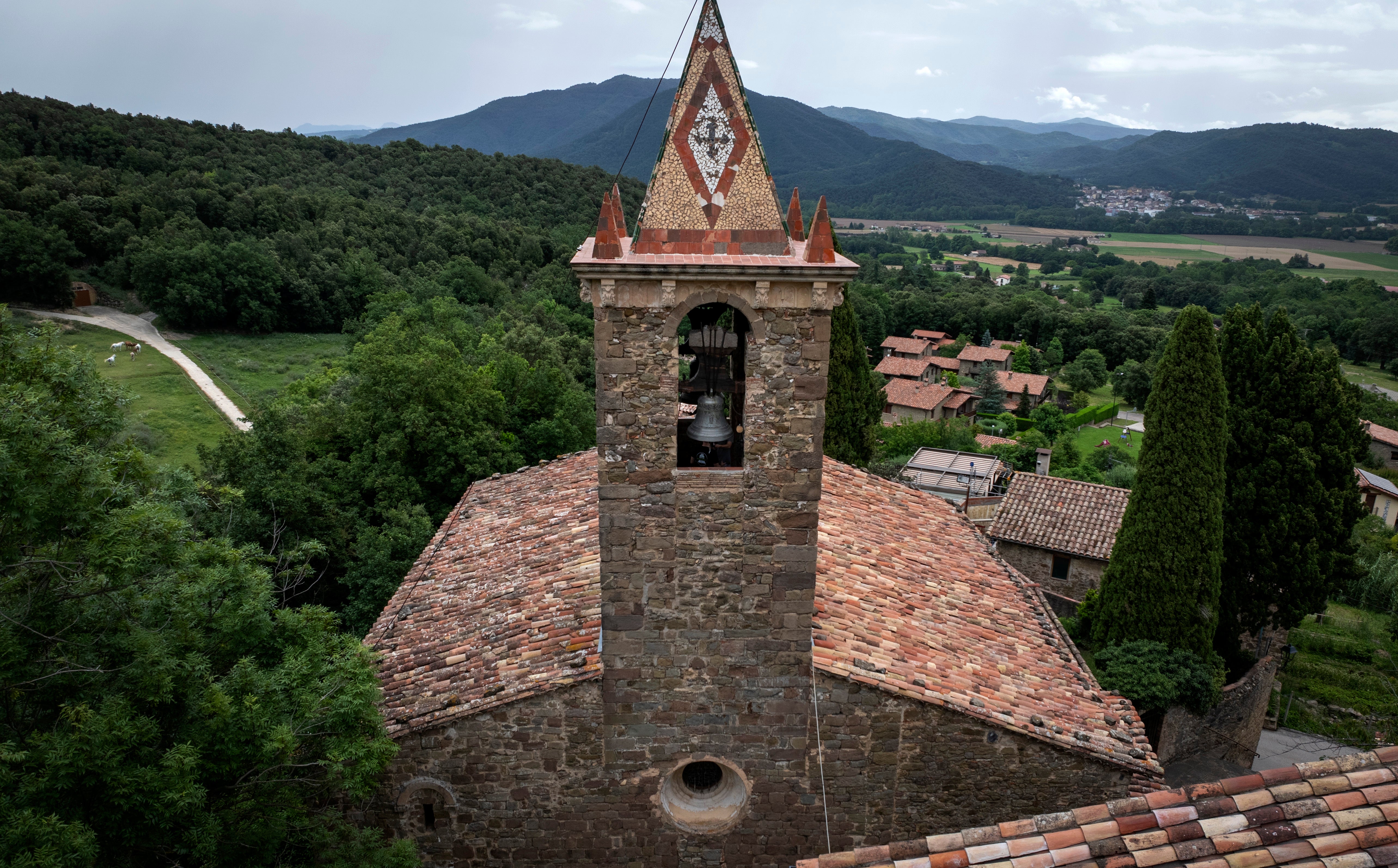 View of the bell tower of the12th-century Sant Romà church, where students of the Vall d’en Bas School of Bell Ringers practice