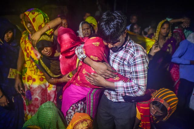 <p>Relatives and villagers at a cremation ceremony in Daukeli village, Hathras, India, on 3 July mourn those who died in a stampede the previous day </p>