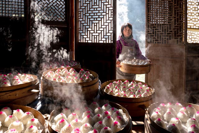 <p>People prepare for a feast to celebrate Spring Festival, or lunar Chinese New Year, in a rural part of Xiangshan, Zhejiang province. Preparations include making dim sum, such as red bean paste balls</p>