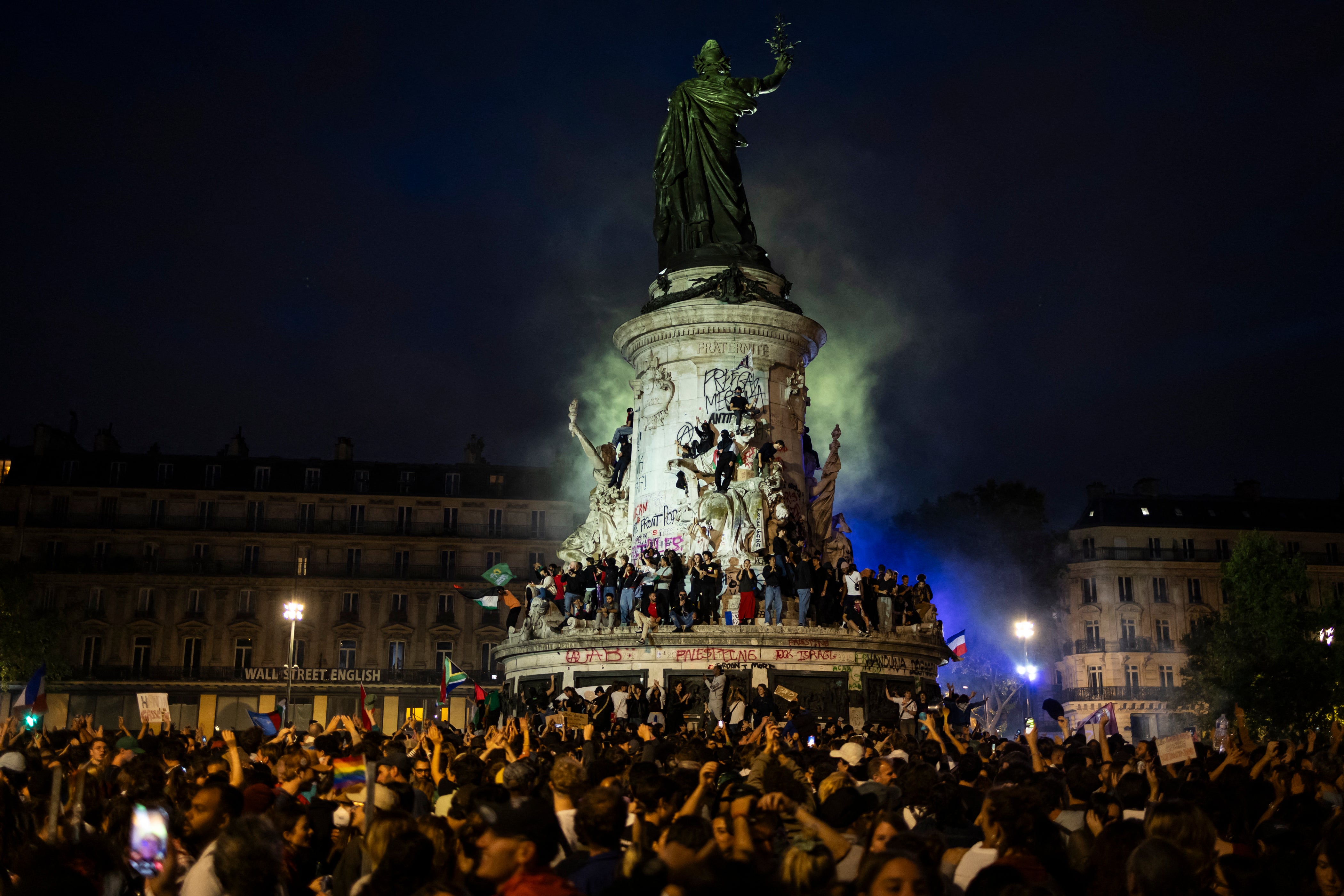 People gather in front of Le Monument a la Republique statue during an election night rally following the first results of the second round of France’s legislative election at Republique Square in Paris on 7 July 2024