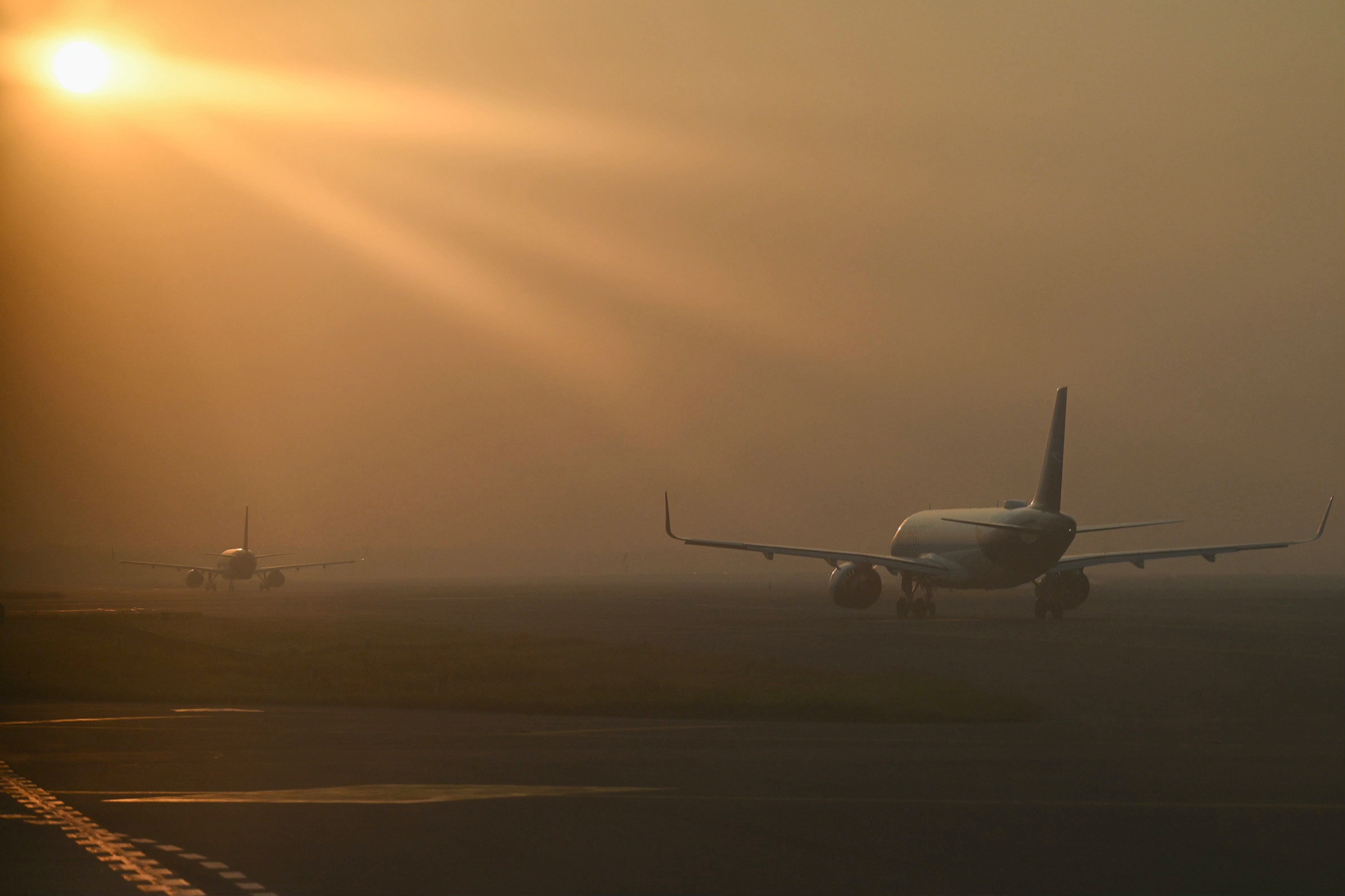 Aircraft line up to take off during heavy air pollution at the Indira Gandhi International Airport in Delhi on 27 October 2023