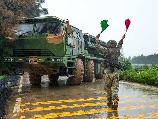 <p> A soldier leads a Chinese rocket launcher at a base during May exercises in eastern China’s Fujian province</p>