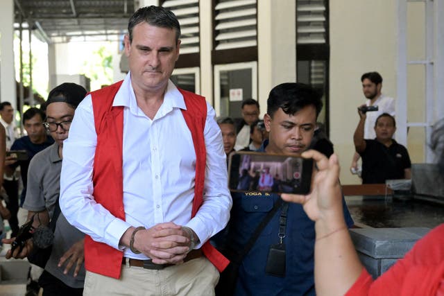 <p>Australian Troy Smith (C) leaves after attending a court hearing as part of his trial in Denpasar on Indonesia’s resort island of Bali on June 13</p>