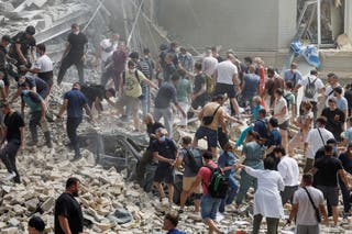 Ukrainians search through rubble after a children’s hospital was hit in a Russian attack on Kyiv