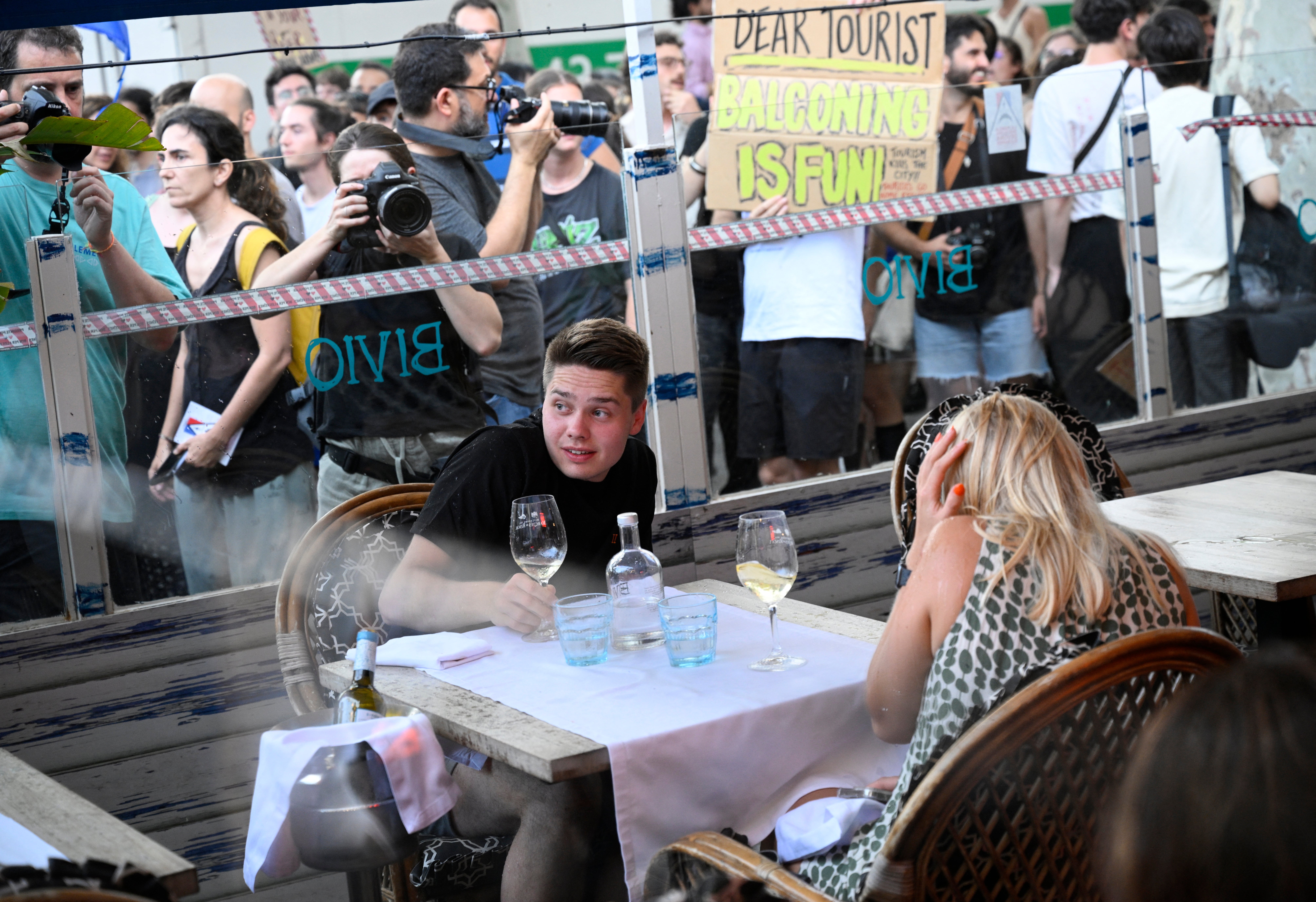 Diners in Barcelona under attack from water pistols during the city’s latest demonstration against overtourism