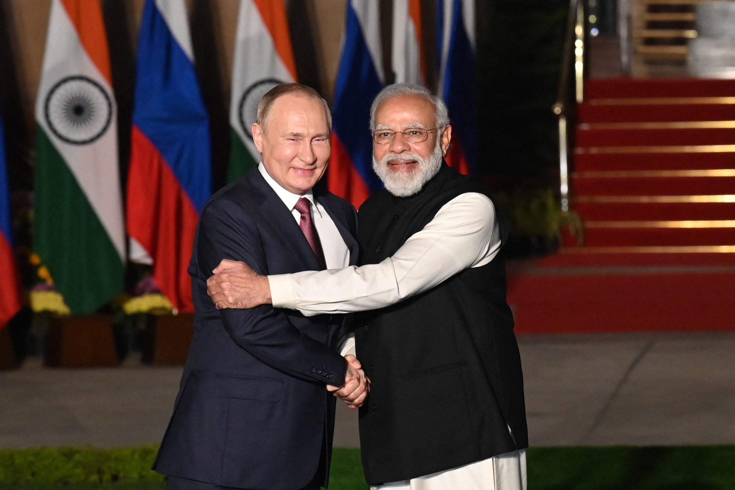 Indian Prime Minister Narendra Modi (R) welcomes Russian President Vladimir Putin prior to their meeting at Hyderabad House in New Delhi in 2018