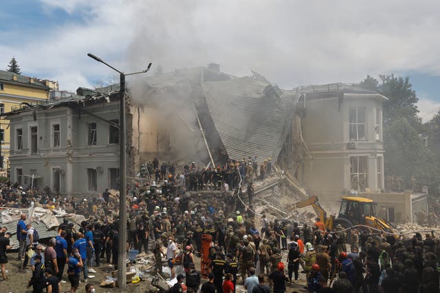 <p>Rescue workers at the site of a rocket strike on the 'Okhmadyt' children's hospital in Kyiv</p>