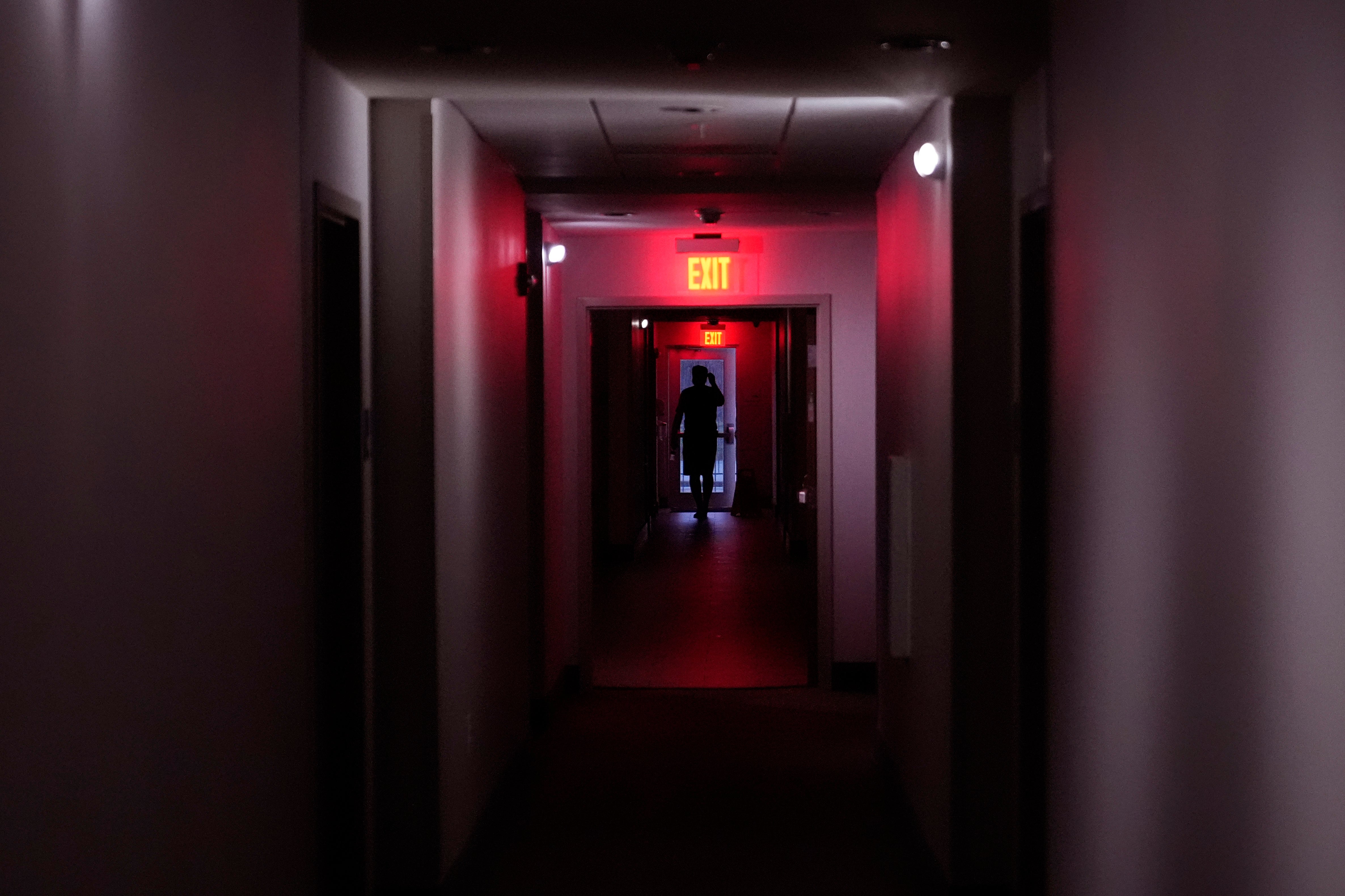 A hotel guest walks through the halls after a power outage caused by Hurricane Beryl, Monday, July 8, 2024, in Bay City, Texas.