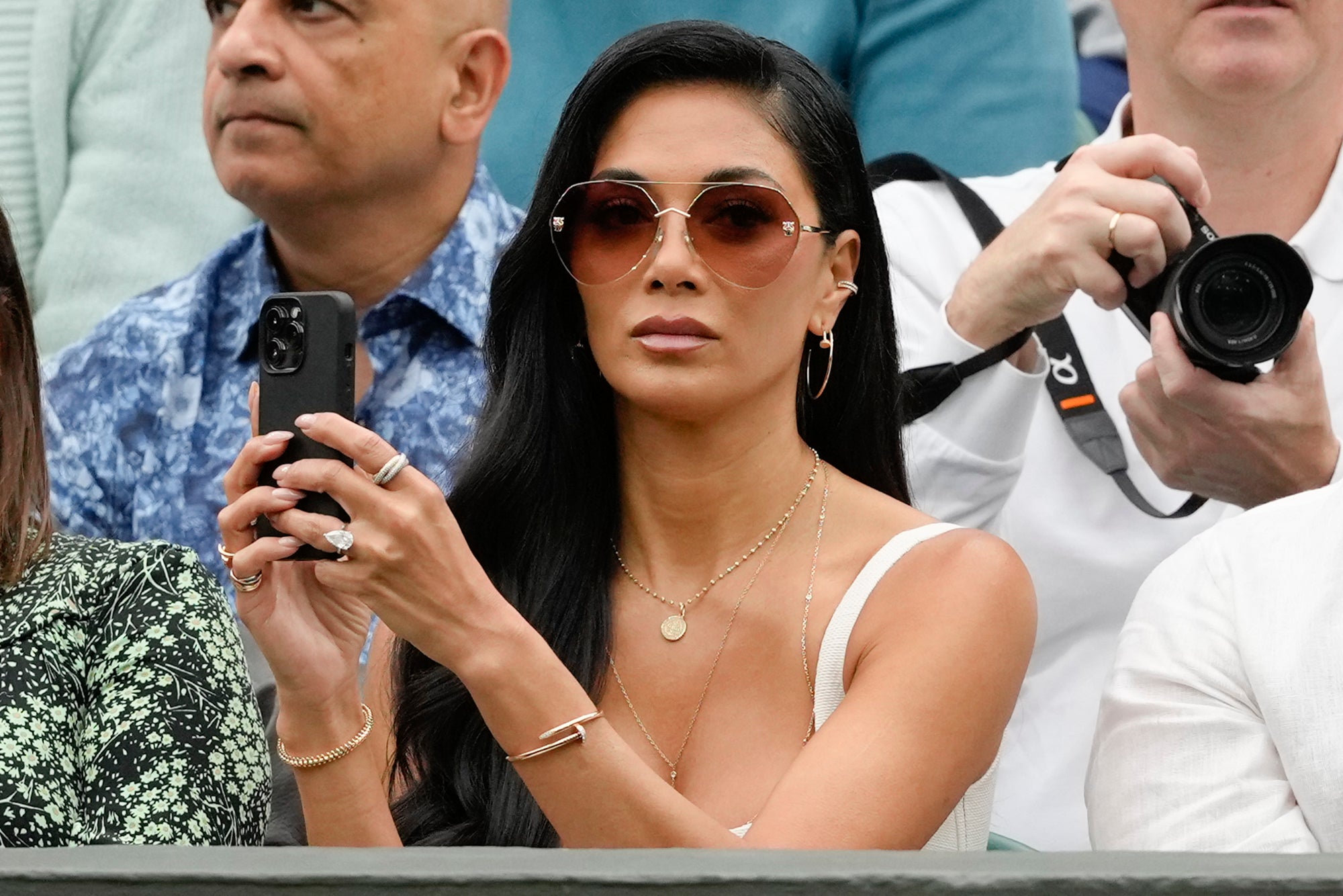 Scherzinger wore sunglasses and a sleeveless dress.