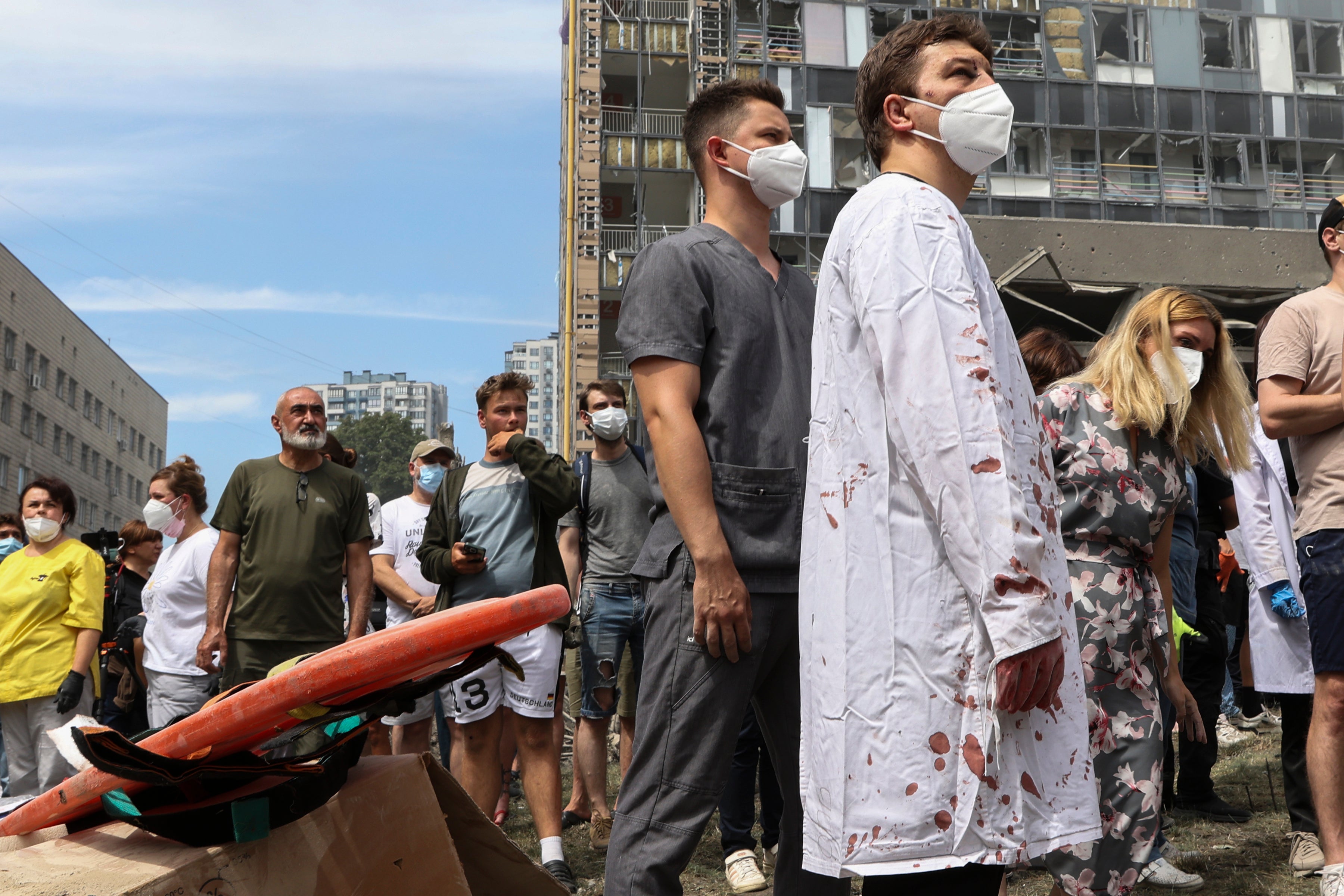 People and medical staff gather to help after Russian missile hit the country’s main children hospital Okhmadit in Kyiv