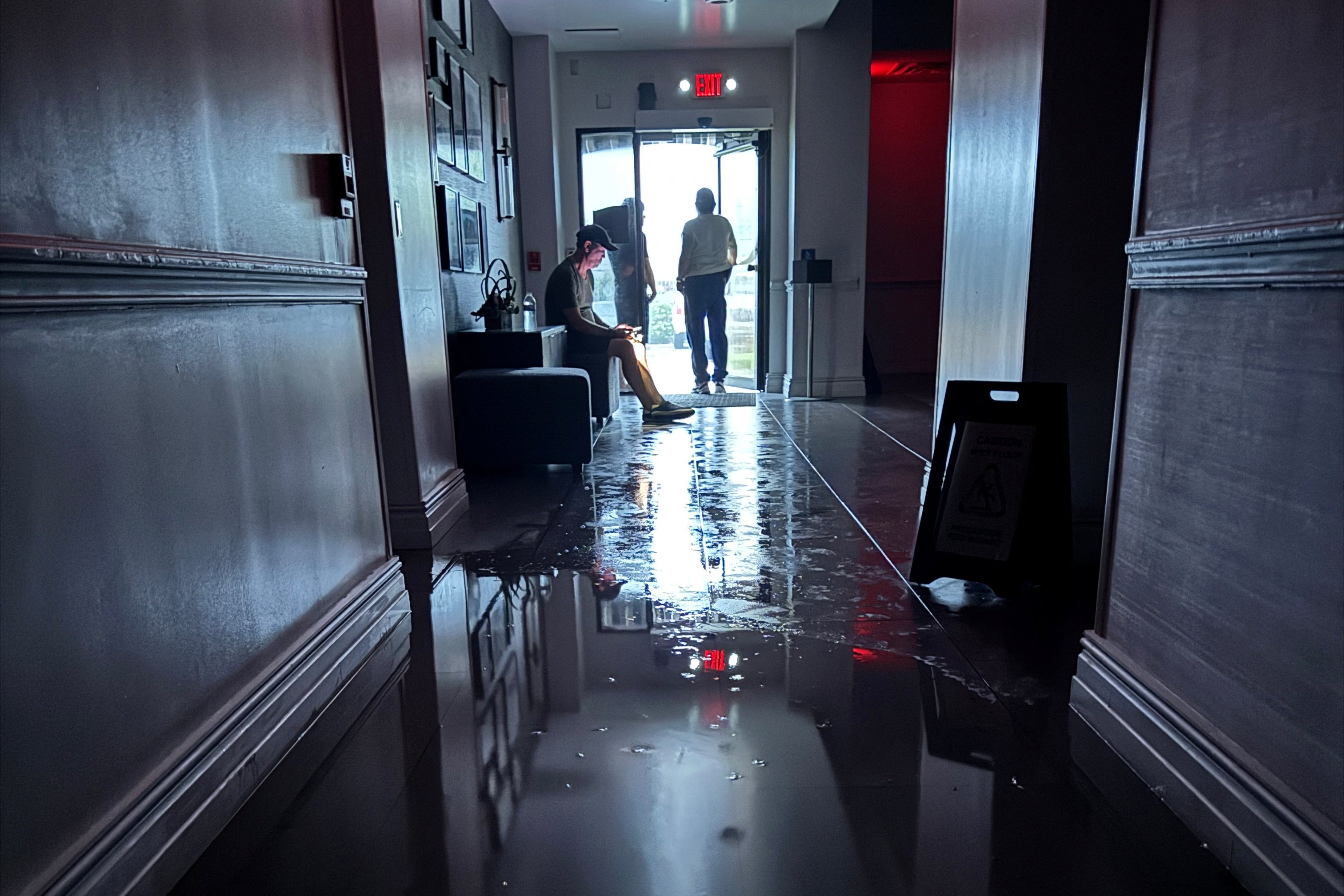 Hotel guests at the Hilton Galveston resort watch the storm through the back door of the hotel as Hurricane Beryl makes landfall in Galveston, Texas, U.S. on July 8, 2024