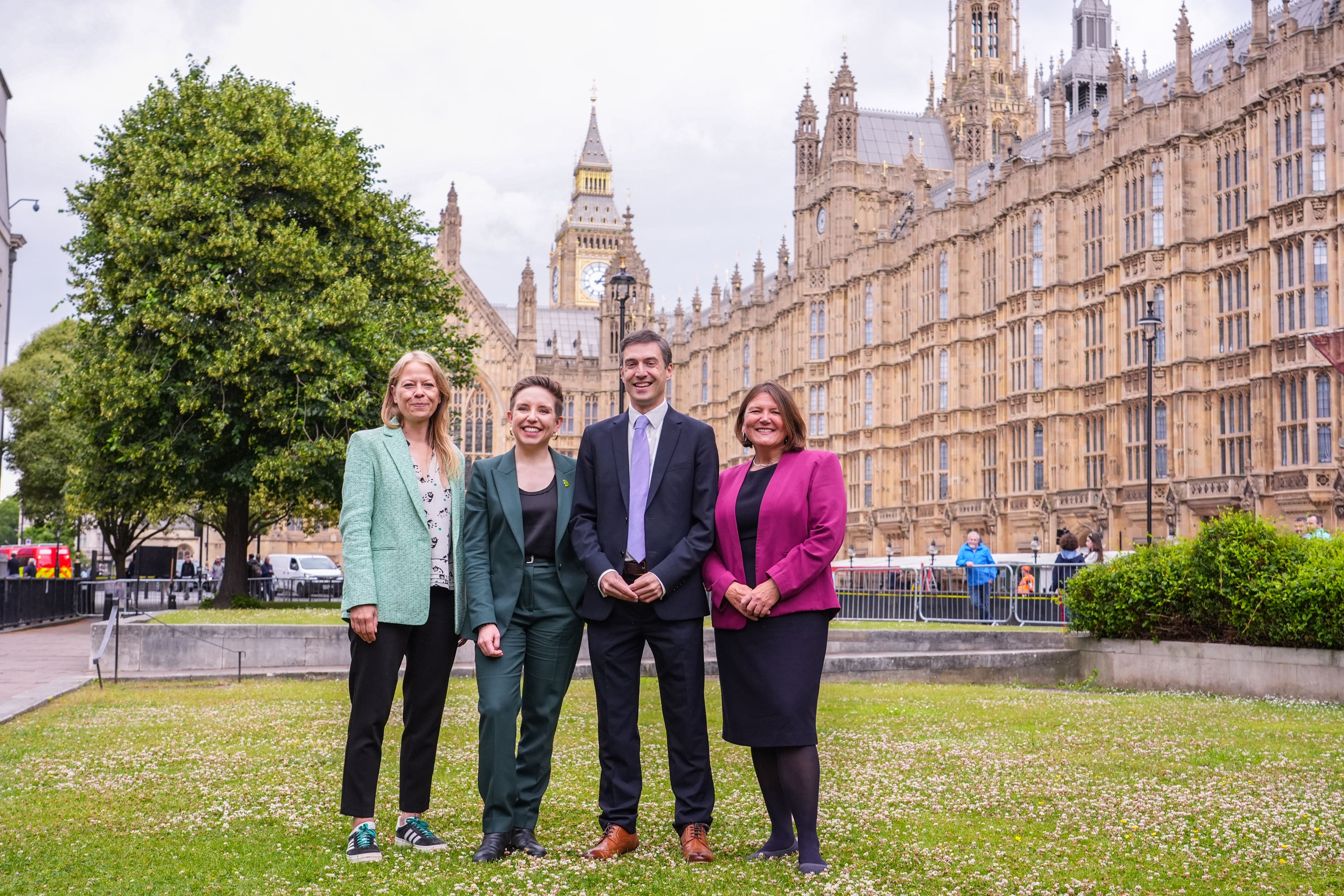 The party’s four new MPs gathered outside the Houses of Parliament (Ian West/PA)