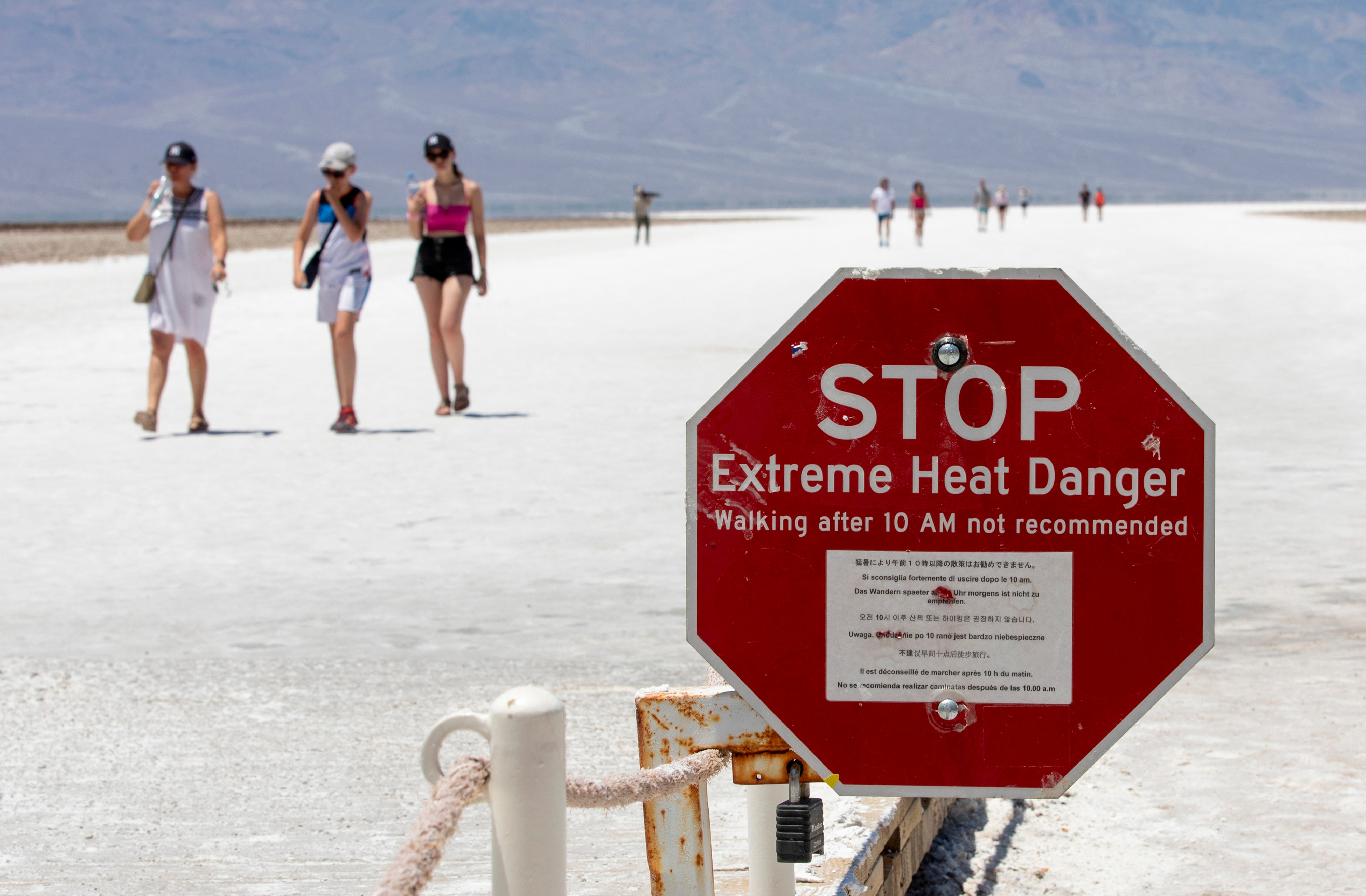A stop sign warns tourists of extreme heat at Badwater Basin, Monday, July 8, 2024, in Death Valley National Park