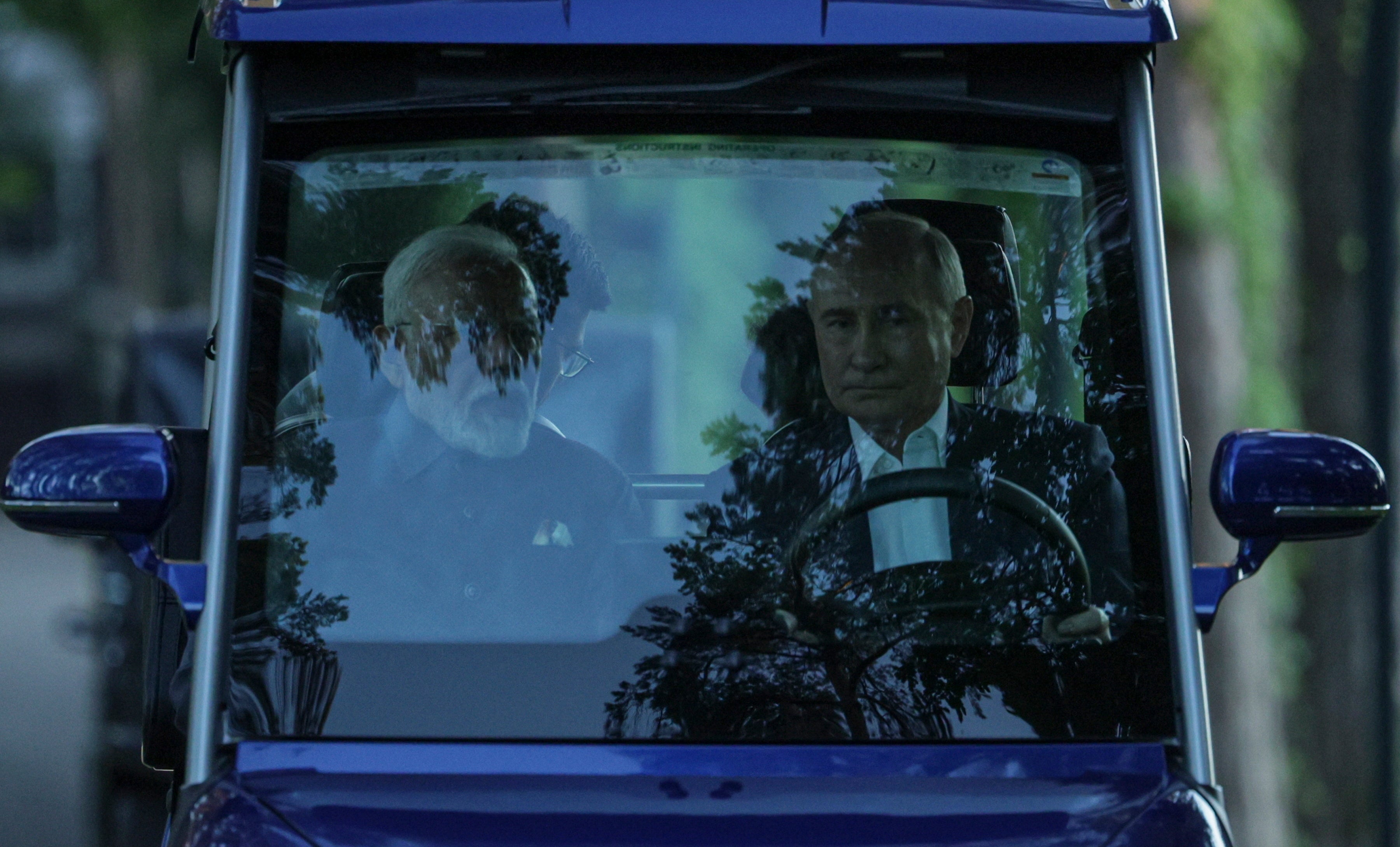 Vladimir Putin and Narendra Modi ride in a golf cart before their meeting in Moscow