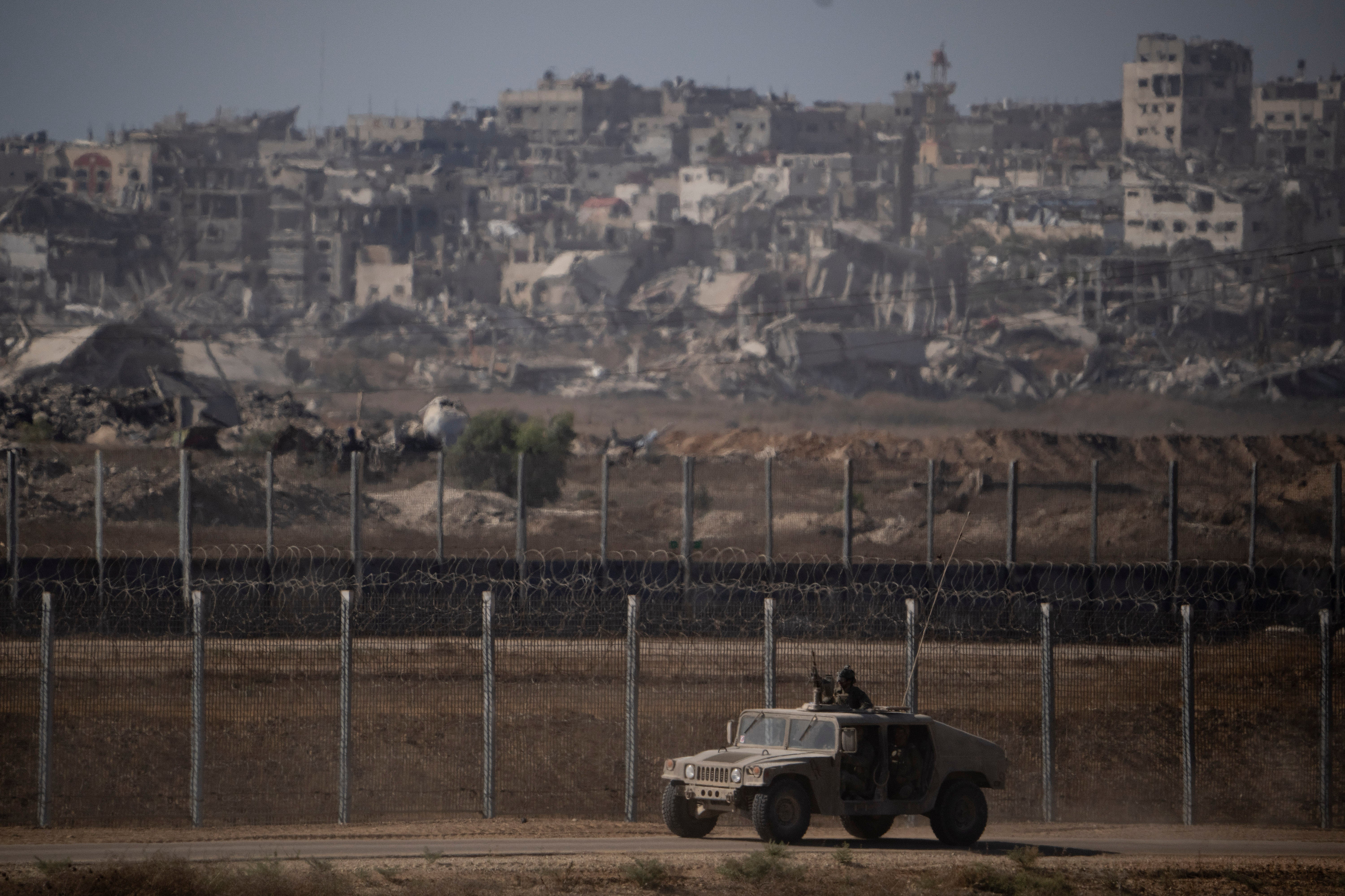 Israeli soldiers move near the Israeli-Gaza border on Monday, ahead of advancing further into Gaza City