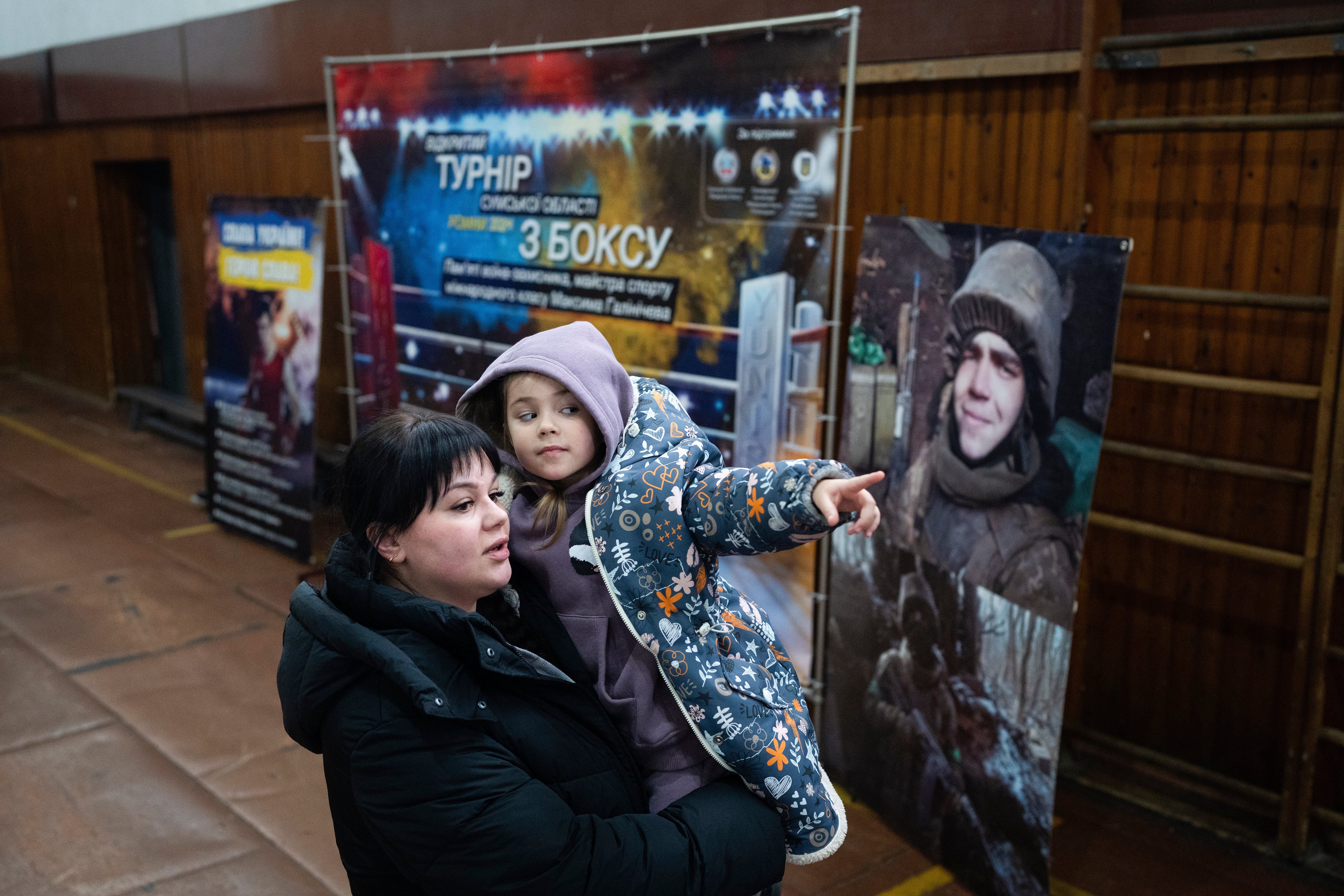 Vasilisa plays with her mother, Polina Ihrak, during a boxing tournament in honor of her father, Maksym Halinichev