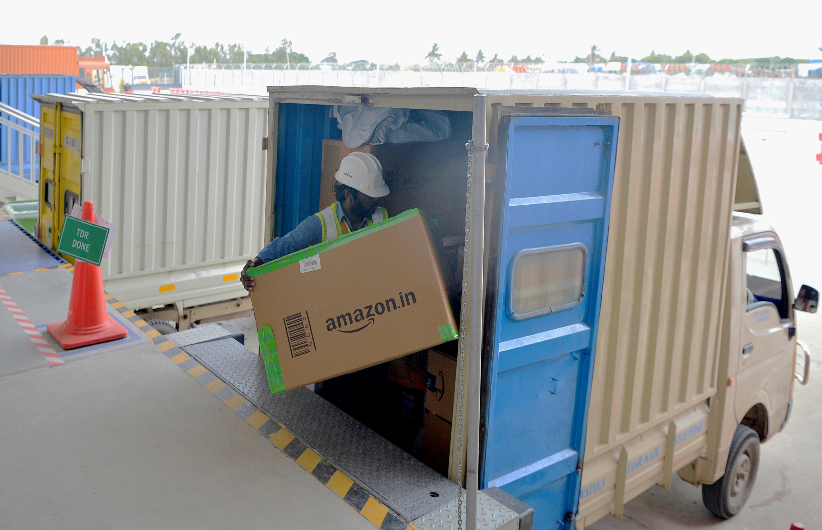 An Amazon India worker loads a van with products for delivery at the company’s warehouse on the outskirts of Bengaluru in 2018