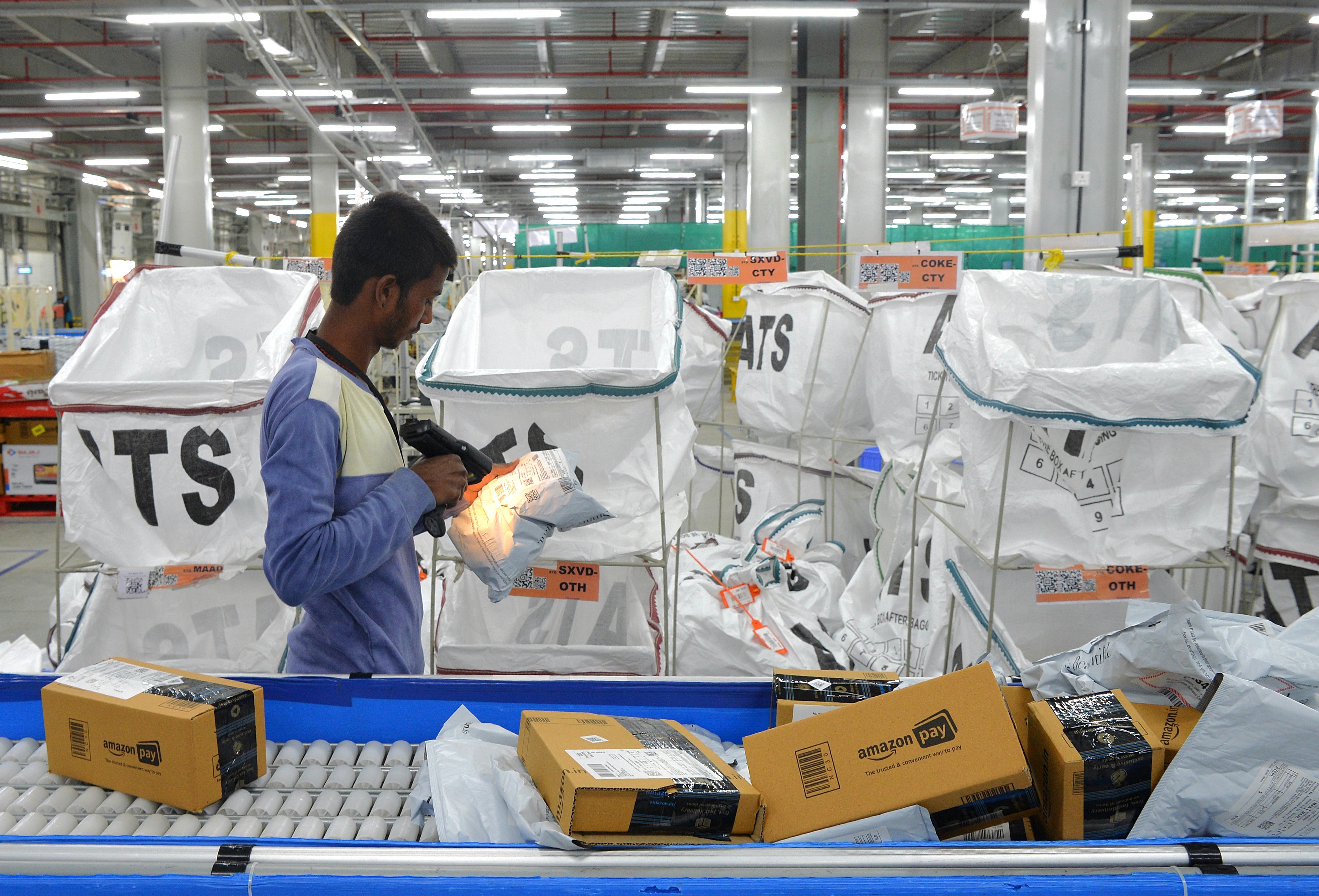 Amazon India workers package boxes for delivery at a warehouse on the outskirts of Bengaluru in 2018