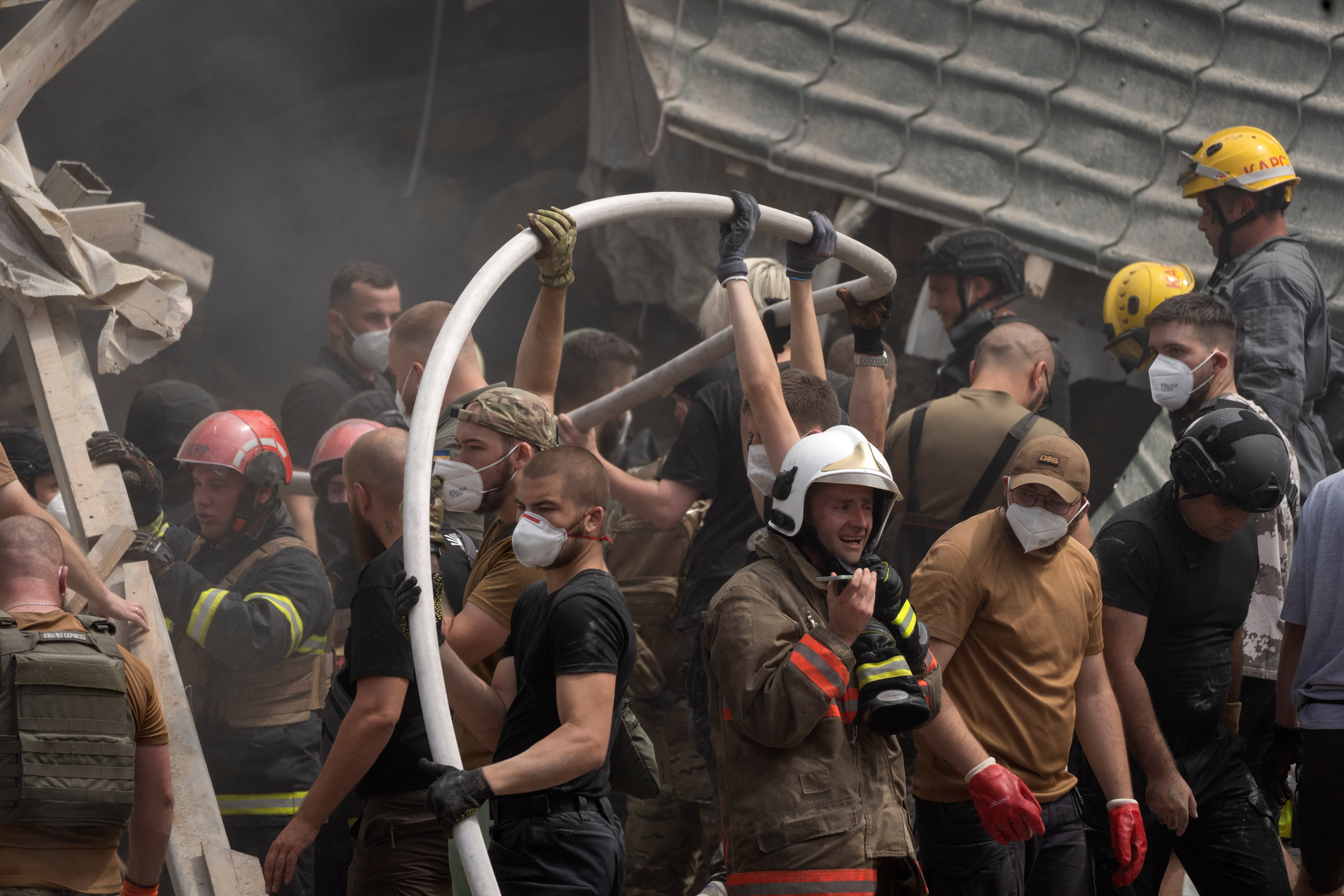 Rescue workers, volunteers and medical staff clear debris and search for victims after a Russian missile hit the country's largest children's hospital, Okhmadit, in Kyiv, Ukraine.