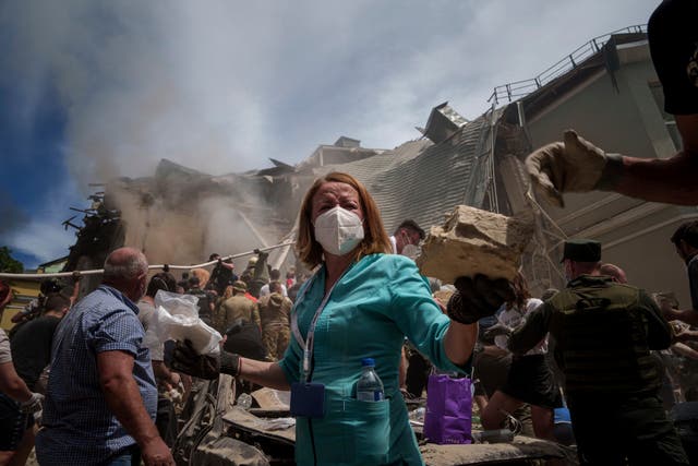 <p>Rescue workers clear the rubble at the Ohmatdyt Children’s Hospital in Kyiv</p>