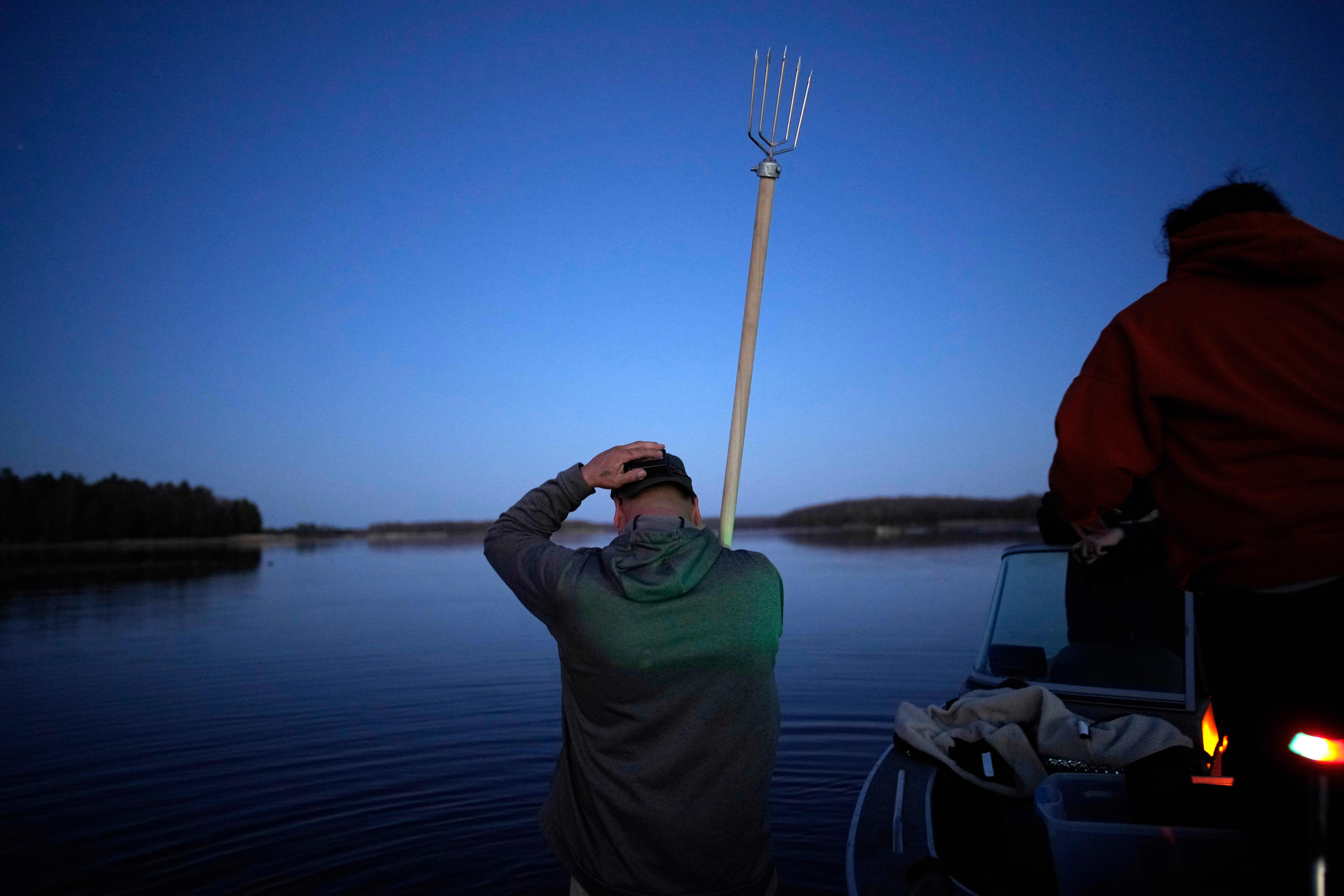 John Baker holds a spear while getting ready to fish at the Chippewa Flowage on the Lac Courte Oreilles Reservation, Sunday, April 14, 2024, near Hayward, Wis. (AP Photo/John Locher)