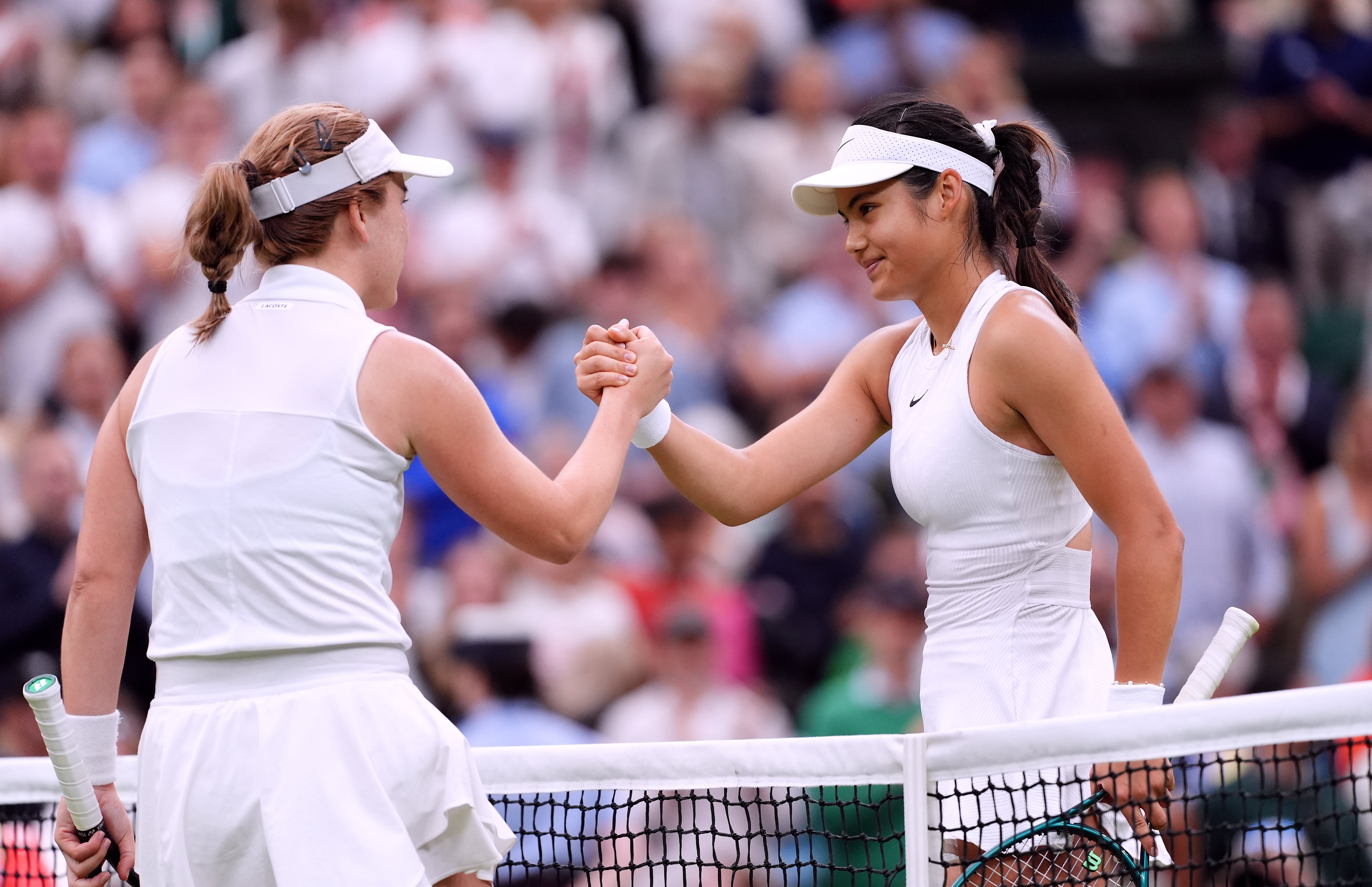 Emma Raducanu, right, shakes hands with Lulu Sun (John Walton/PA)