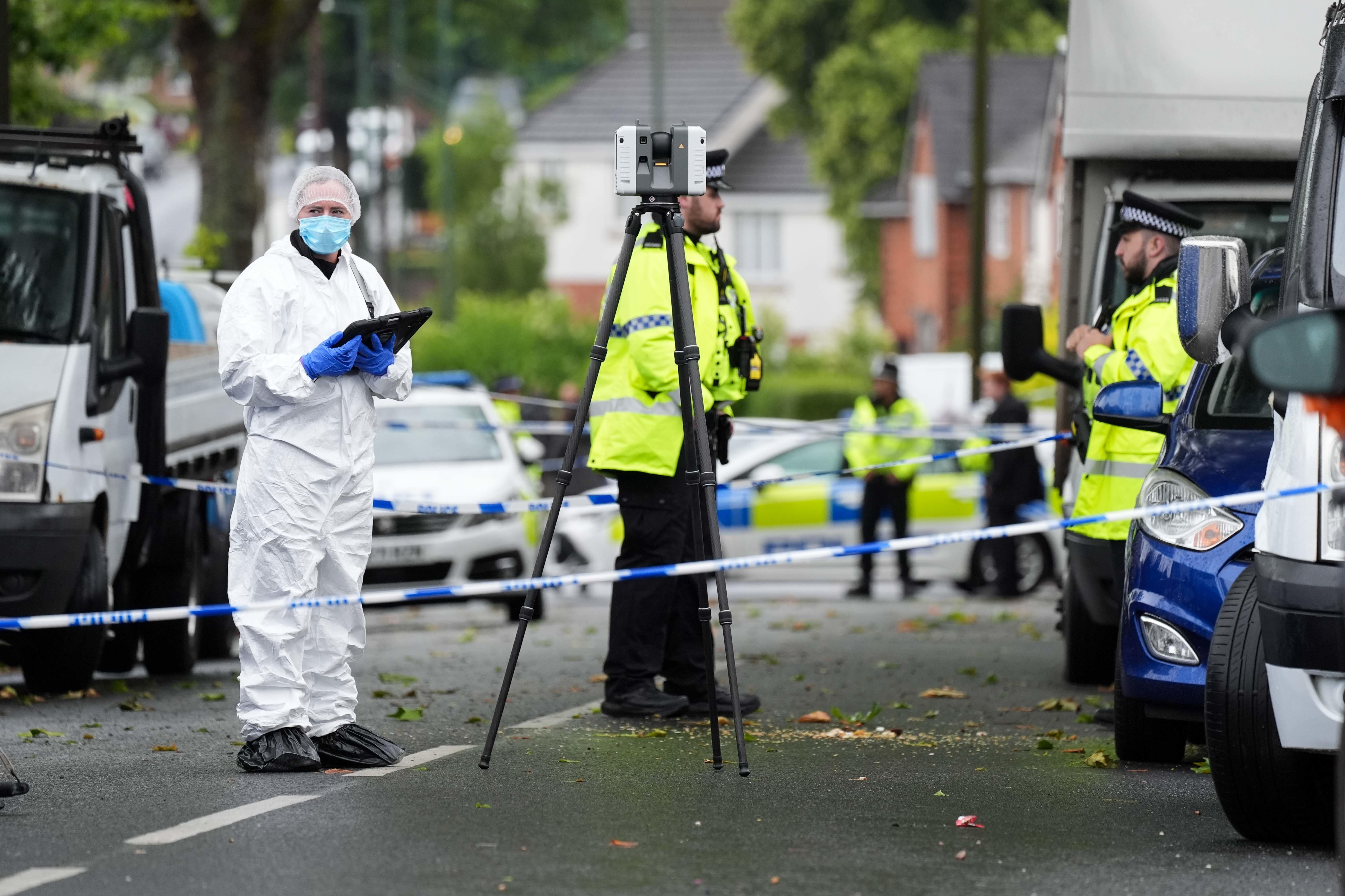 Police and forensics officers at the scene of a fatal shooting in Walsall (Jacob King/PA)