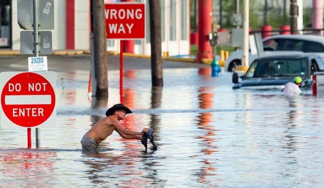 <p> A man navigates flood waters following heavy rain from Hurricane Beryl in Houston, Texas, USA, 08 July 2024</p>