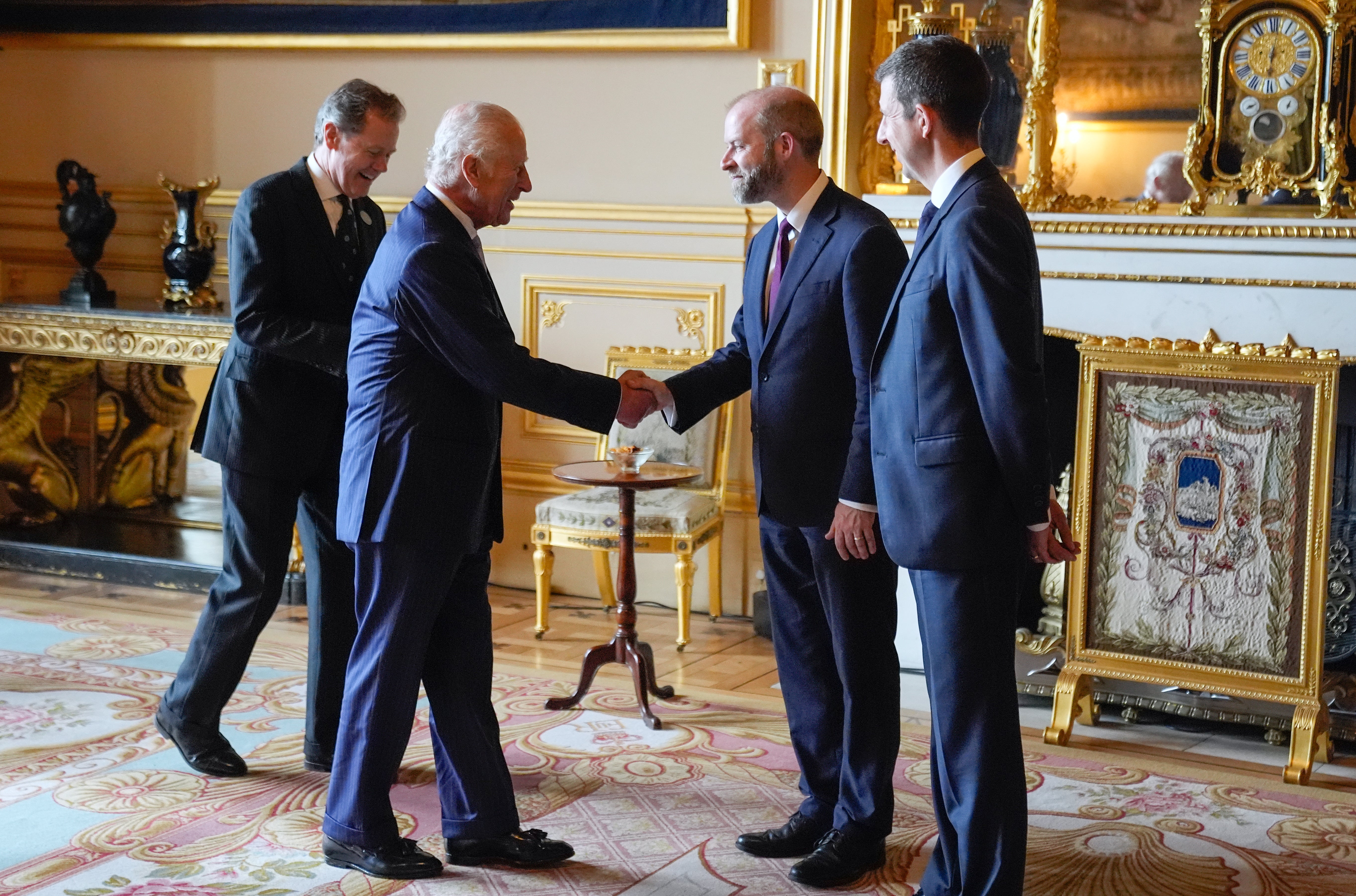 The King shakes hands with Business and Trade Secretary Jonathan Reynolds (Andrew Matthews/PA)