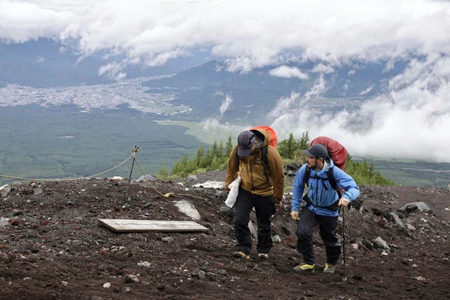 <p>Trekkers climb the Yoshida trail to the top of Mount Fuji in Yamanashi prefecture, Japan, on Monday</p>