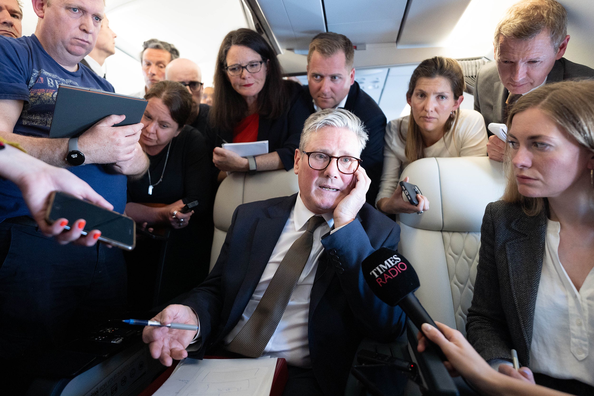 Sir Keir Starmer talks to journalists as he travels on board a plane to Washington