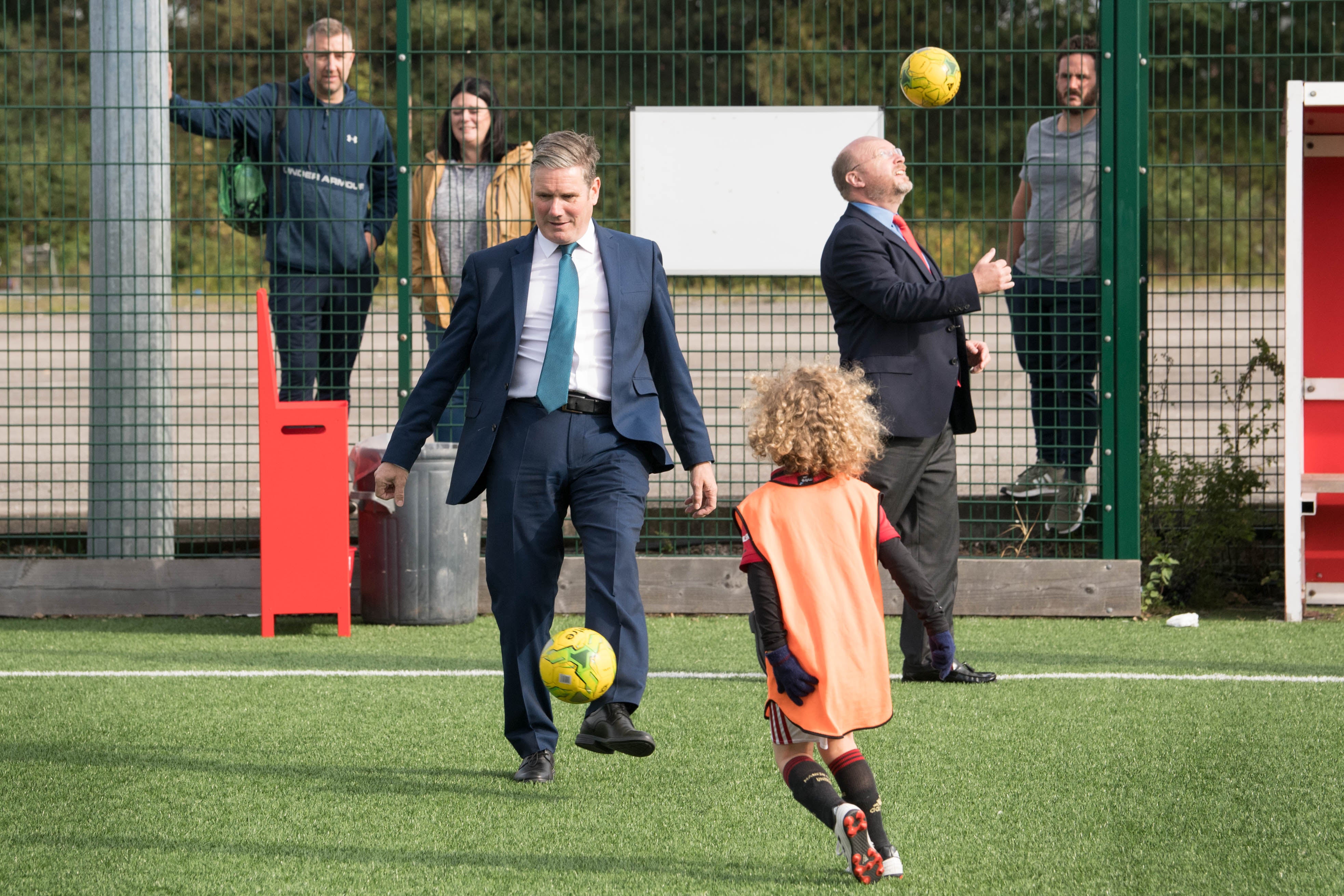 Sir Keir Starmer (left) with MP Liam Byrne, playing football during a visit to Walsall football club
