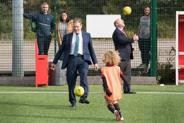 <p>Sir Keir Starmer (left) with MP Liam Byrne, playing football during a visit to Walsall football club</p>