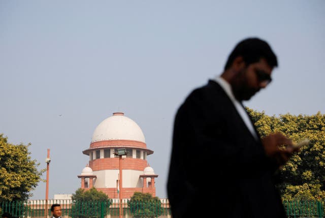 <p>File: A lawyer looks at his mobile phone in front India's supreme court in New Delhi</p>