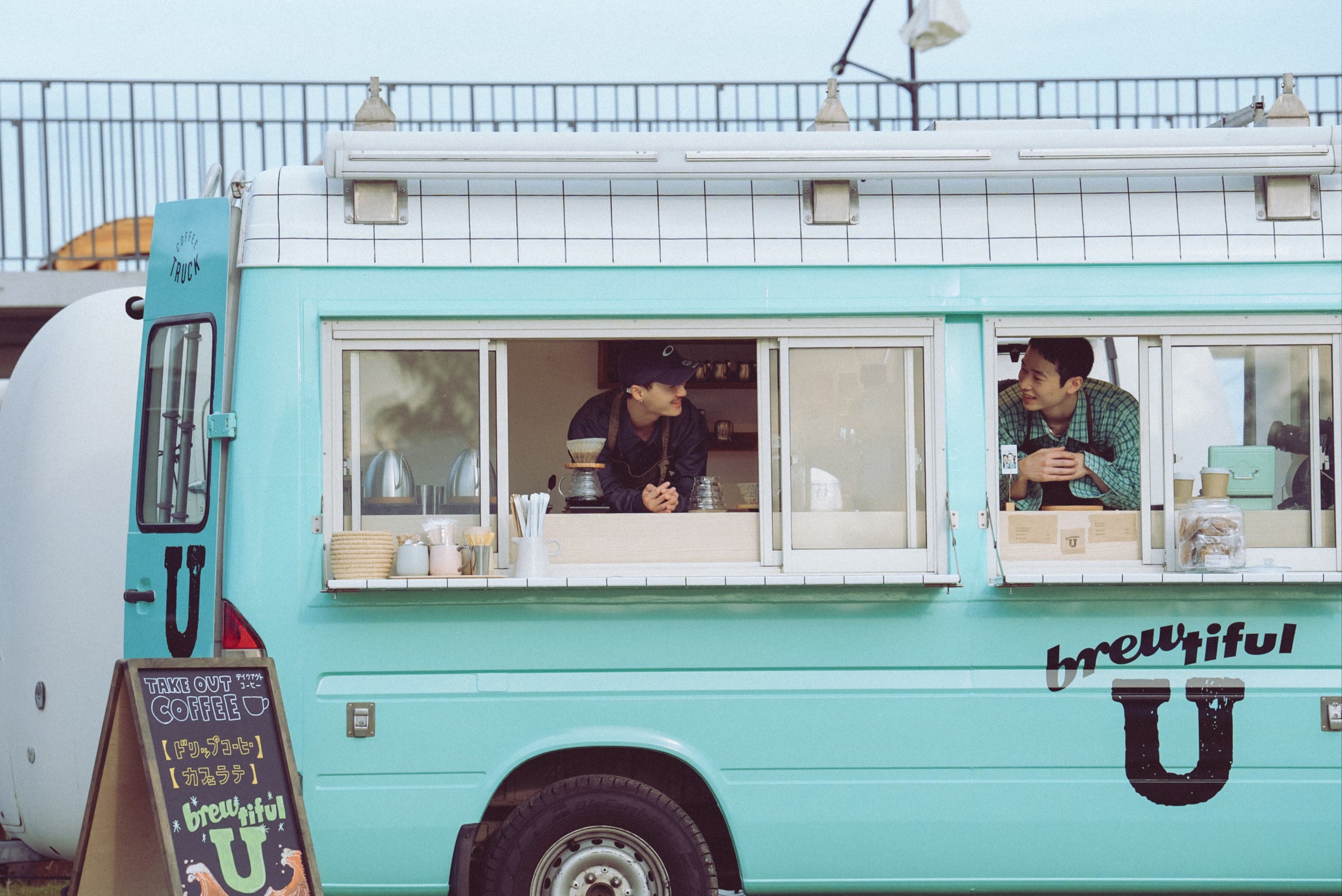 The contestants live together while working in a coffee van