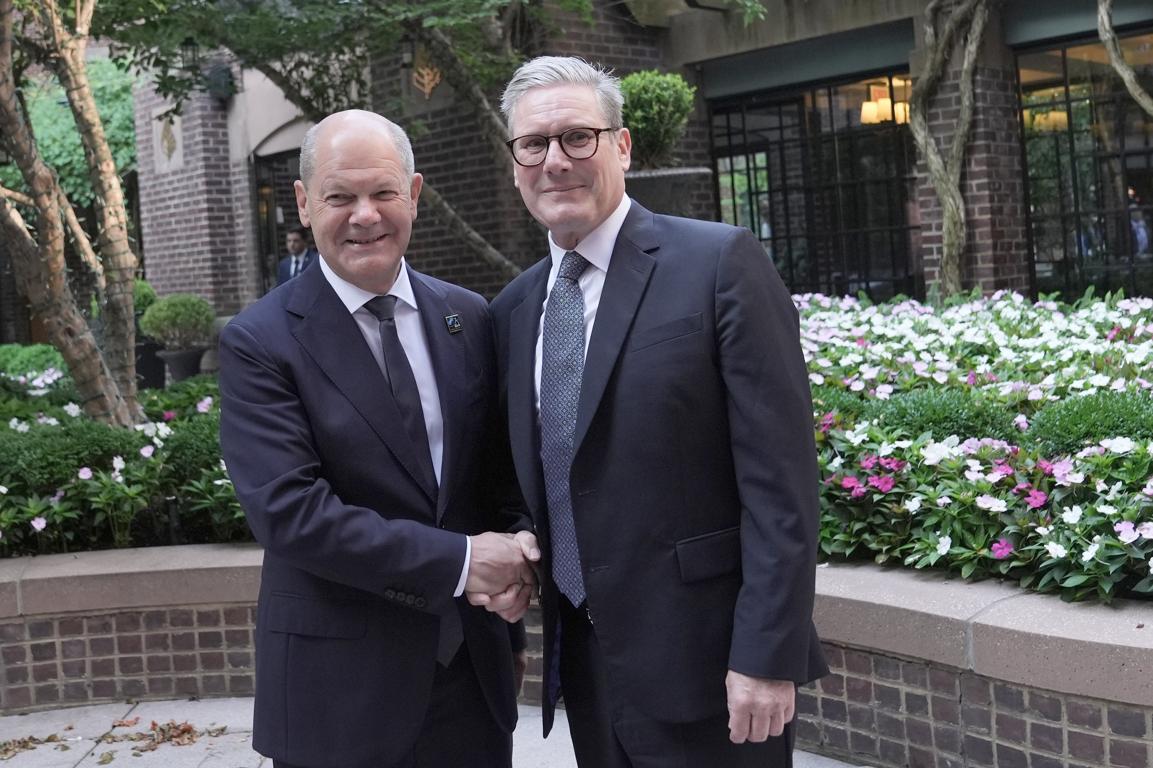 British Prime Minister Sir Keir Starmer (R) is seen meeting German Chancellor Olaf Scholz, for a bilateral meeting at a hotel in Washington DC, ahead of the Nato summit