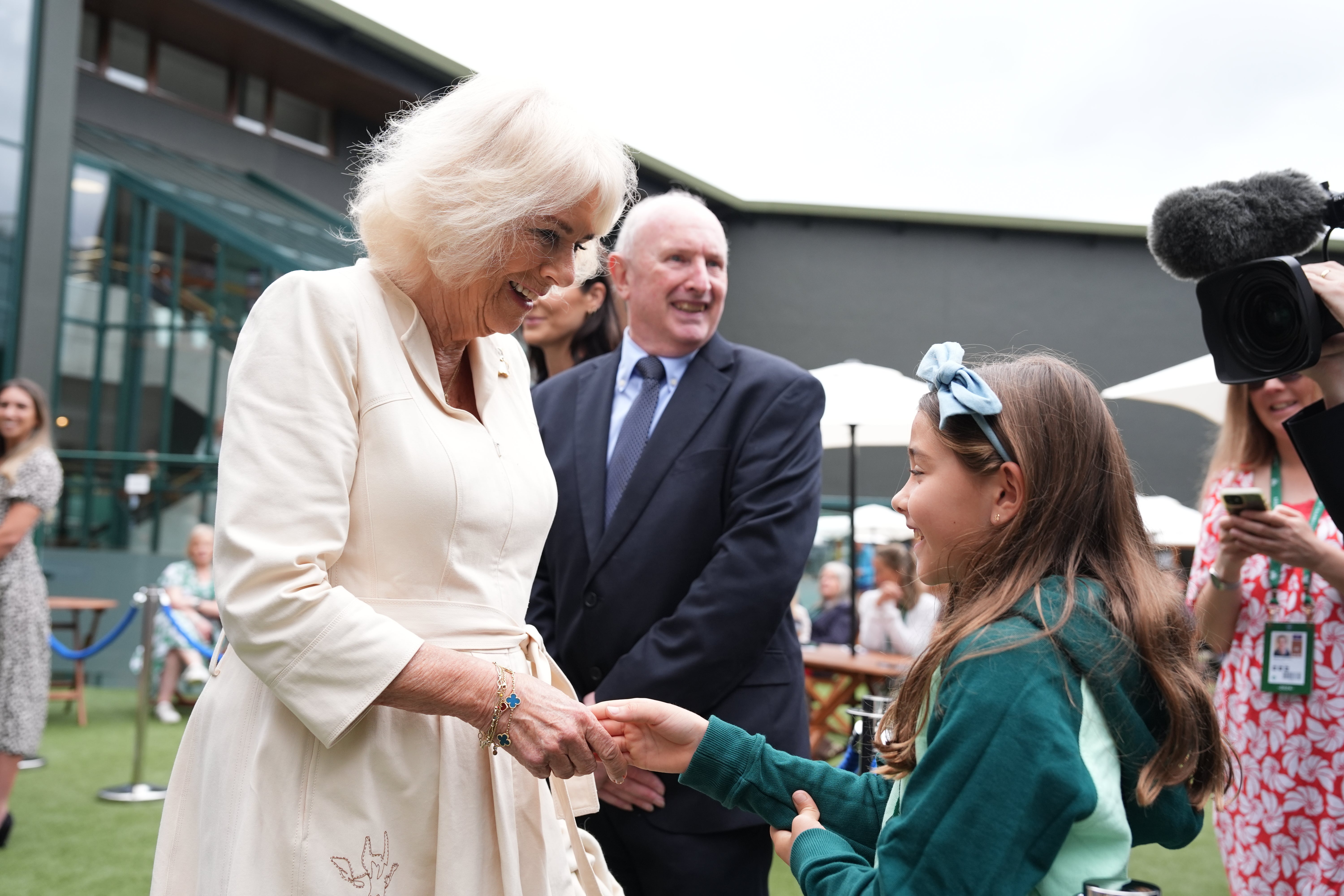 Camilla meets Camila, daughter of Mexican tennis player Santiago Gonzalez (Jordan Pettitt/PA)