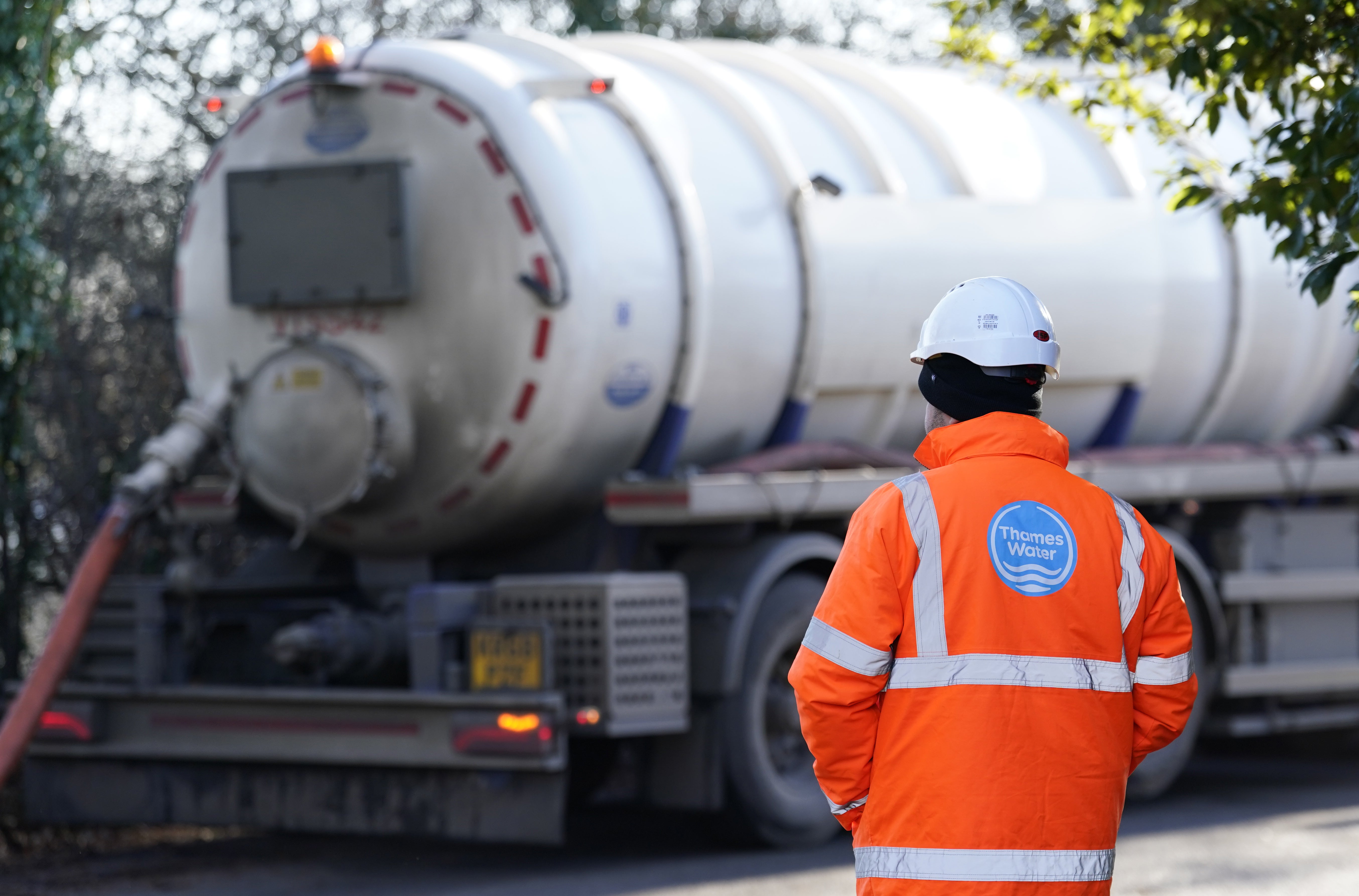 A Thames Water employee watches as a tanker pumps out excess sewage from the Lightlands Lane sewage pumping station in Berkshire