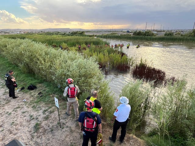 <p>Rescuers stand near the Rio Grande river in Sunland Park, New Mexico, where 54 migrants were pulled from the water on July 9, 2024</p>
