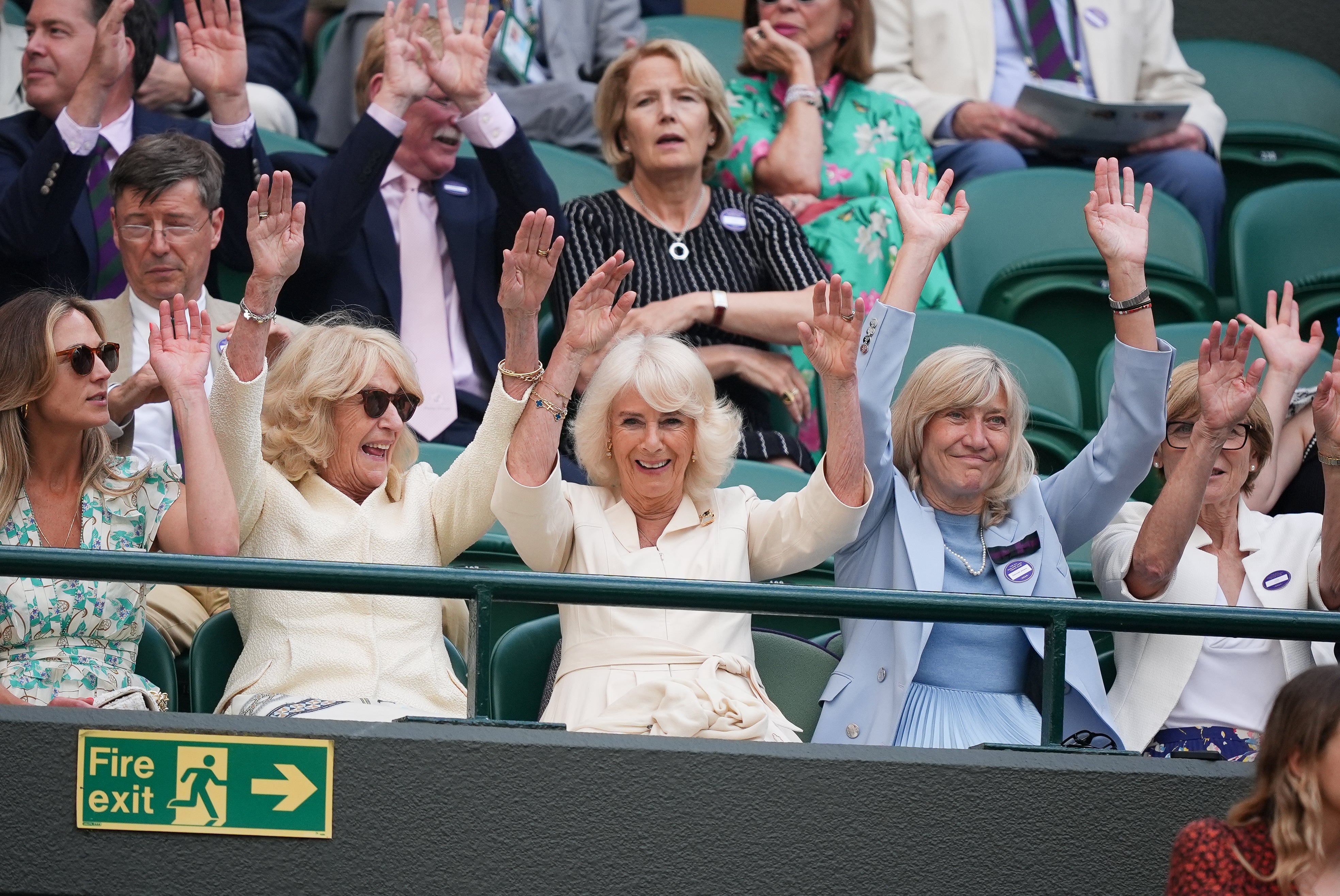 The Queen (centre) takes part in a Mexican wave after she left the Royal Box on Centre Court to watch Lorenzo Musetti versus Taylor Fritz on Court One (Jordan Pettitt/PA)